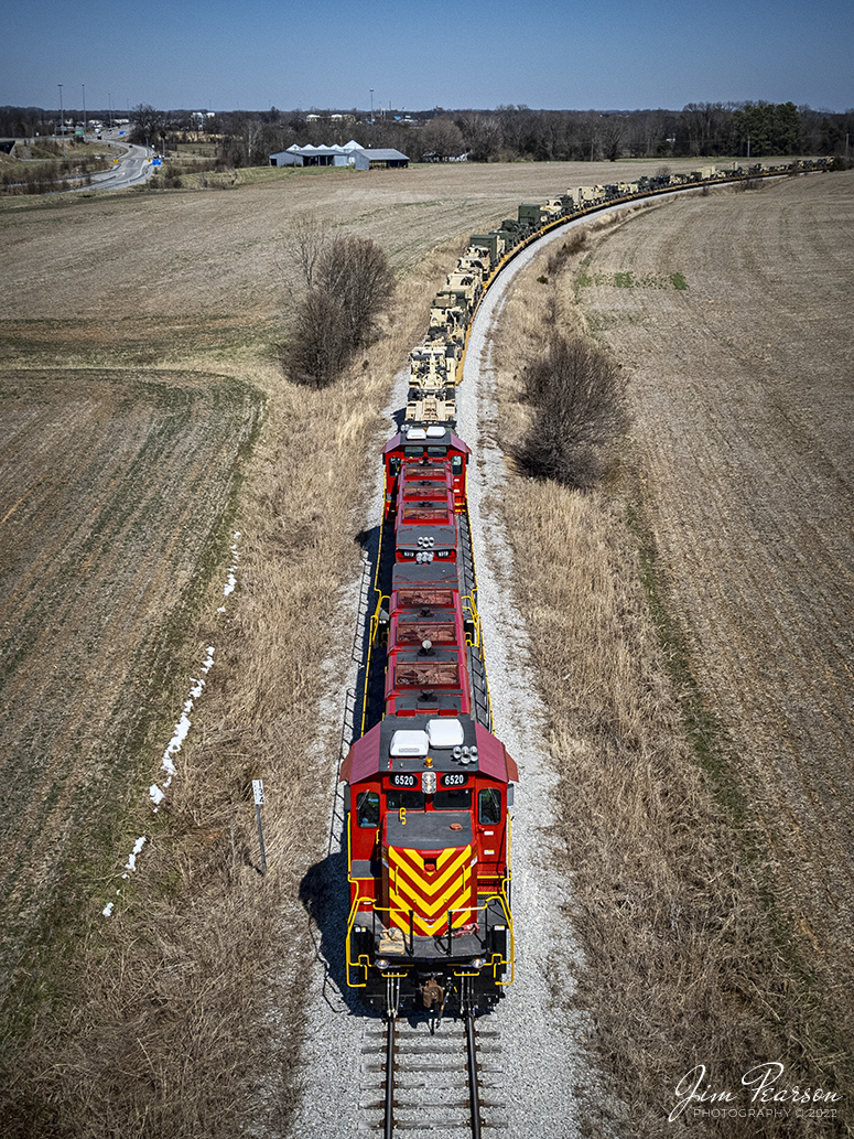 On March 14th, 2022 United States Army Gensets 6520 and 6519 prepare to pull south to Ft. Campbell, Ky, under the Lovers Lane Overpass, at Hopkinsville, Kentucky with another loaded military train, returning from military exercises somewhere out west.  

The equipment was delivered by CSX S864, which was a Rose Lake, IL - Hopkinsville, Ky train and was one of about 5 trains that ran down the CSX CE&D and Henderson Subdivisions to Hopkinsville over the past week, returning equipment from training to Ft. Campbell.

Tech Info: DJI Mavic Air 2S Drone, RAW, 22mm, f/2.8, 1/3000, ISO 100.

#trainphotography #railroadphotography #trains #railways #dronephotography #trainphotographer #railroadphotographer #jimpearsonphotography