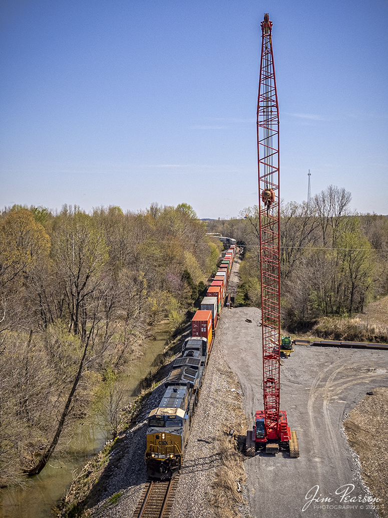 CSXT 3293 leads I025 as it passes a crane just south of downtown Hanson, Kentucky on April 19th, 2022, as it heads south on the Henderson Subdivision. Preparations are underway at this spot to replace the bridge that the train is rolling across just south of the south end signals for the siding at Hanson.

Tech Info: DJI Mavic Air 2S Drone, RAW, 22mm, f/2.8, 1/2000, ISO 110.

#trainphotography #railroadphotography #trains #railways #dronephotography #trainphotographer #railroadphotographer #jimpearsonphotography
