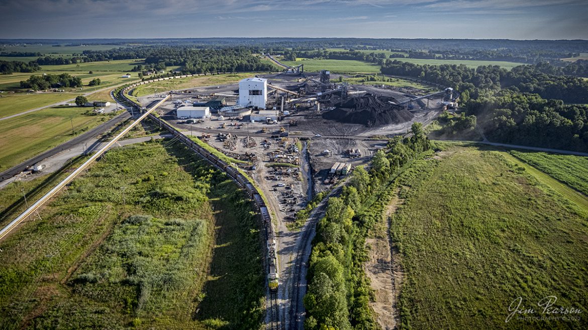 Several firsts for me in this drone image from June 24th, 2022, showing the whole loop at Warrior Coal outside Nebo, Kentucky! On this Norfolk Southern coal train, we find NS Illinois Terminal Heritage Unit 1072 leading with Paducah and Louisville University of Kentucky locomotive, 4522 trailing, as they prepare to load an empty coal drag, with NS Southern Heritage Unit 8114 bringing up the rear. 

This was my first time catching a coal train with a heritage unit leading and as a DPU on the rear, plus doing so on the Paducah and Louisville Railway with one of the University of Kentucky units in the consist was pretty cool!

Tech Info: DJI Mavic Air 2S Drone, RAW, 22mm, f/2.8, 1/1500, ISO 130.

#trainphotography #railroadphotography #trains #railways #dronephotography #trainphotographer #railroadphotographer #jimpearsonphotography