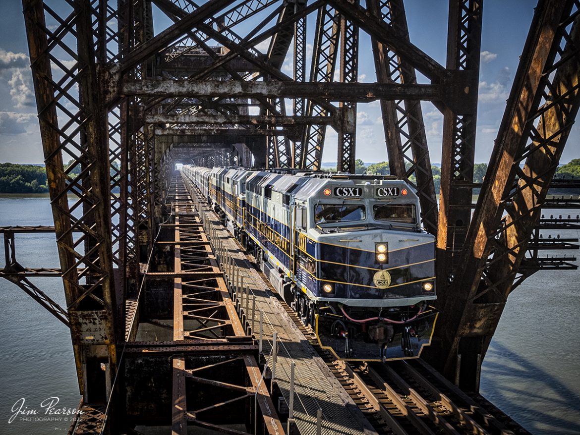 CSX P001-23 Office Car Special passenger train makes its way across the old L&N bridge over the Ohio River as it heads south at Henderson, Kentucky with CSXT 1, 2 and 3 leading the way on the Henderson Subdivision on August 23rd, 2022.

CSX repainted these three-executive fleet F40PH locomotives in a paint scheme inspired by predecessor Baltimore & Ohio and a fleet of cars to finish out the train set. The city of Baltimore chartered the railroad on Feb. 28, 1827, to build west to a suitable point on the Ohio River. Ground was broken on July 4, 1828, at Carrollton, Md. By 1929 the railroad operated 5,658 miles of track and had 2,364 locomotives. In the 1970s the B&O became part of Chessie System and in the 1980s it became part of CSX.

Tech Info: DJI Mavic Air 2S Drone, RAW, 22mm, f/2.8, 1/1250, ISO 100.