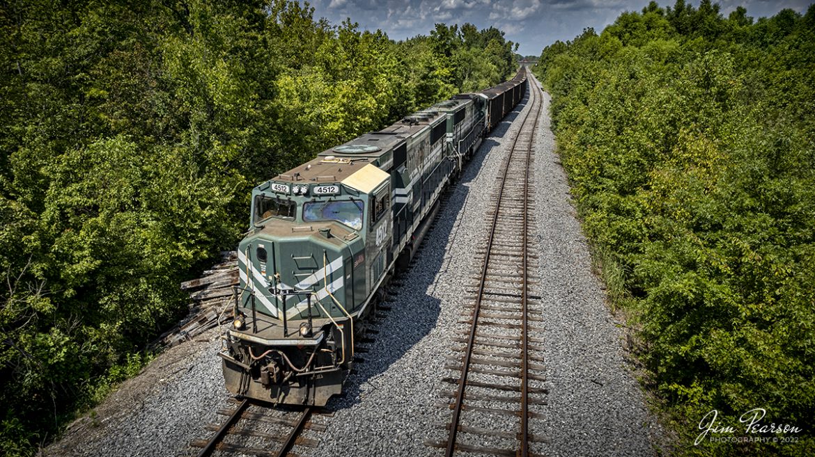 Paducah and Louisville Railway (PAL) locomotive leads a loaded coal train south past the siding at Dawson Springs, Kentucky on August 26th, 2022. The trailing unit is an Evansville Western locomotive, which is also owned by the PAL. They picked the coal up at Warrior Coal Mine, outside Madisonville, KY. Im not sure if it was headed to Calvert City loadout or somewhere on the Evansville Western route up in southern Indiana. 

According to Wikipedia: The Paducah & Louisville Railway is a Class II railroad that operates freight service between Paducah and Louisville, Kentucky. The line is located entirely within the Commonwealth of Kentucky. The 270-mile line was purchased from Illinois Central Gulf Railroad in August 1986.

Tech Info: DJI Mavic Air 2S Drone, RAW, 22mm, f/2.8, 1/1500, ISO 100.

#trainphotography #railroadphotography #trains #railways #dronephotography #trainphotographer #railroadphotographer #jimpearsonphotography
