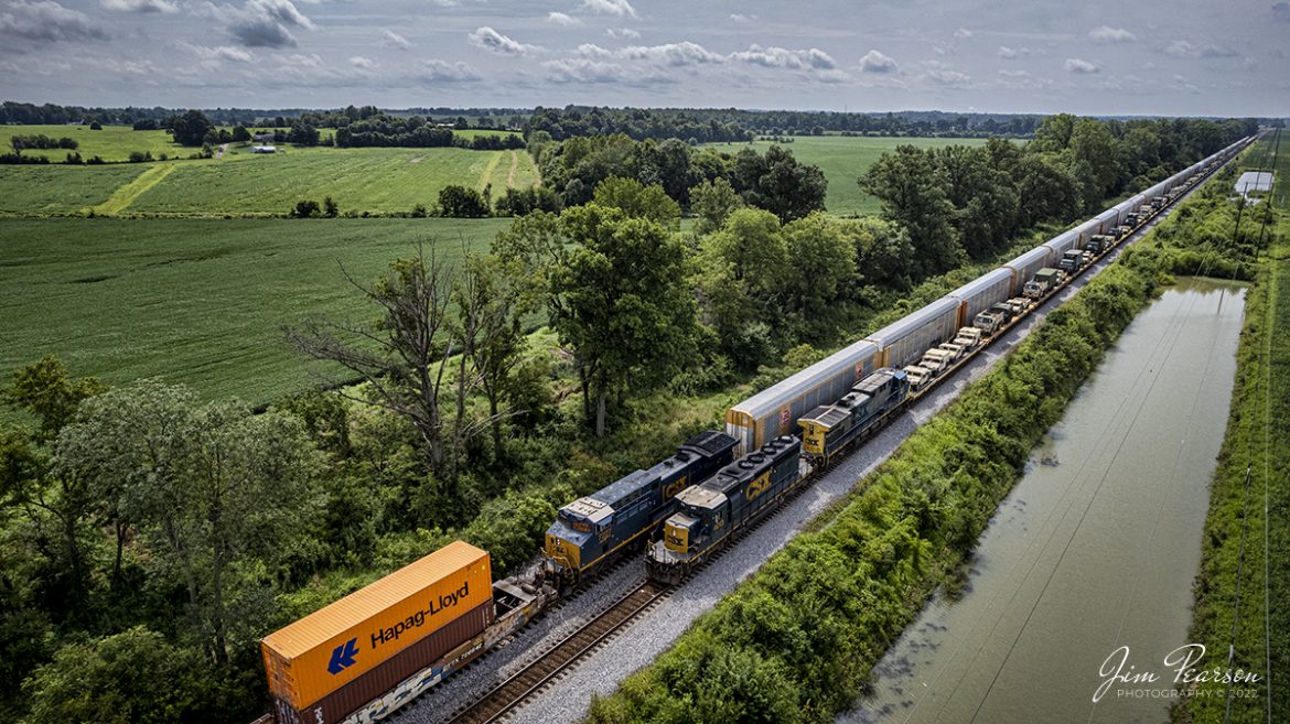 CSX loaded military train S850 sits in the siding at the north end of Rankin, Kentucky as they meet a southbound I025 on the Henderson Subdivision on August 4th, 2022. This intermodal has been running with these autoracks loaded with Teslas on their way south. Today’s train had 25 autoracks. The cars range in price from $46,000 - $120,000, depending on the model.

Military Humvees cost around $70,000 each. Upgraded humvee variants, called armored or up-armored Humvees, carry higher price tags that range from $160,000 to $220000. A lot of money being moved here, not even including the intermodal shipments!

Tech Info: DJI Mavic Air 2S Drone, RAW, 22mm, f/2.8, 1/2000 ISO 100.

#trainphotography #railroadphotography #trains #railways #dronephotography #trainphotographer #railroadphotographer #jimpearsonphotography