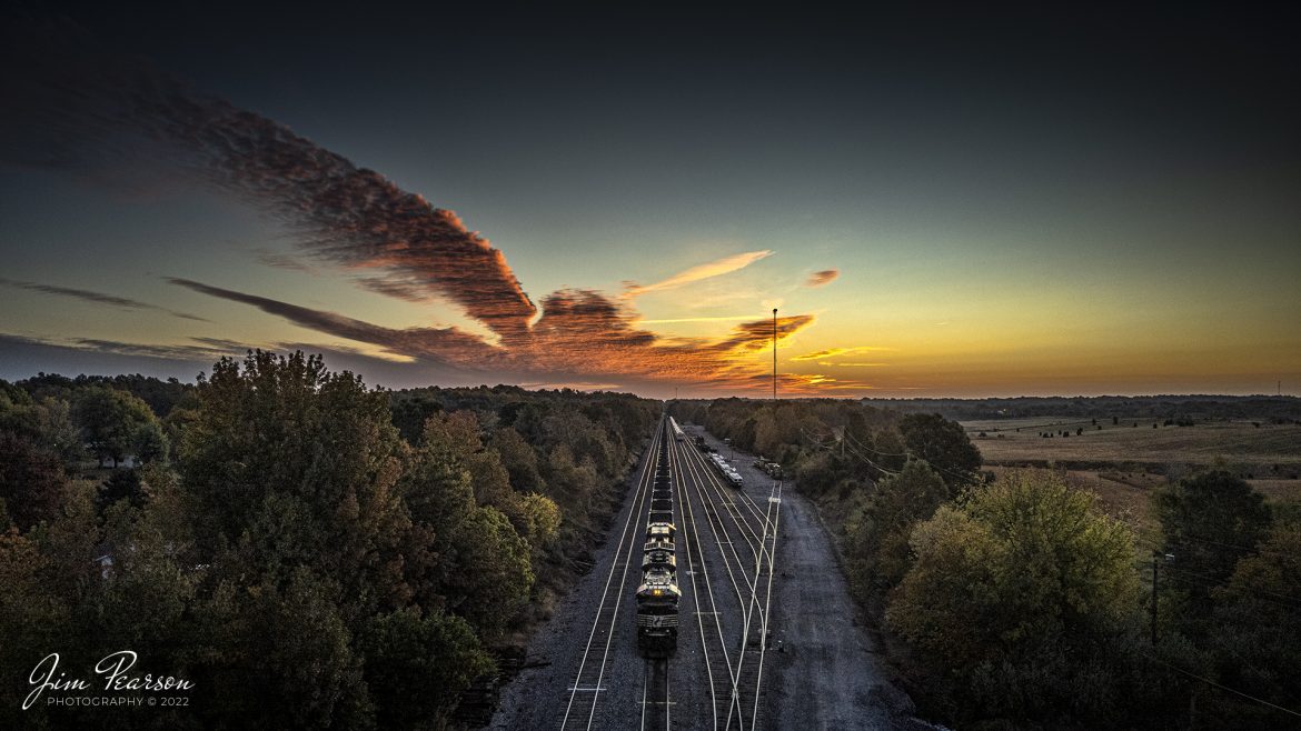 The DPU (Distributive Power Unit) end of a Norfolk Southern loaded coal train waits on track two for a crew to take it north from Madisonville, Kentucky as the early morning sun begins to light up the sky over the Paducah and Louisville Railway yard, on October 17th, 2022.

DPU  Stands for Distributed Power Unit, a locomotive set capable of remote-control operation in conjunction with locomotive units at the train's head end. DPUs are placed in the middle or at the rear of heavy trains (such as coal, grain, soda ash and even manifest) usually to help climb steep grades.

Tech Info: DJI Mavic Air 2S Drone, RAW, 22mm, f/2.8, 1/200, ISO 100, -1stop.

#trainphotography #railroadphotography #trains #railways #dronephotography #trainphotographer #railroadphotographer #jimpearsonphotography #indianatrains #indiananortheasternrailroad