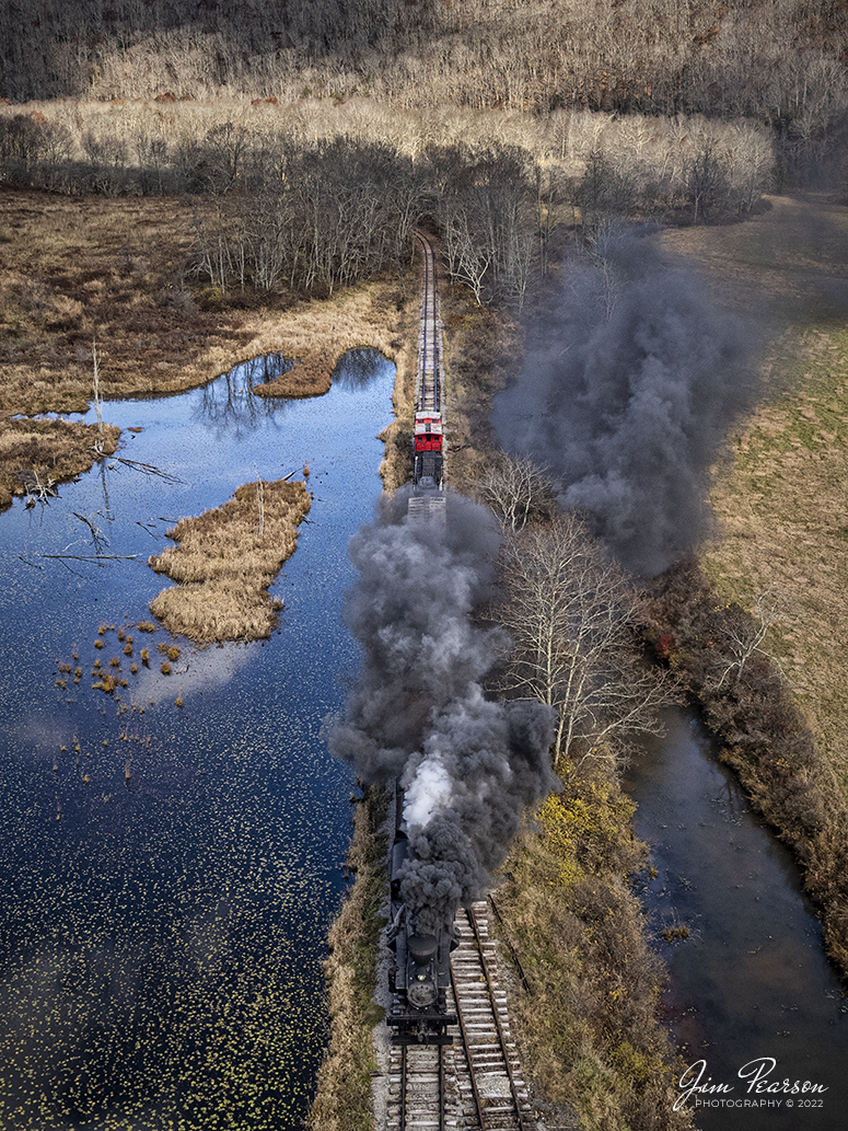 Meadow River Lumber Company steam locomotive, Heisler No. 6, leads a freight train past a wetlands area at Hosterman, West Virginia during the Mountain Rail WV, Rail Heritage Photography Weekend. The event was held at the Durbin & Greenbrier Valley Railroad, Durbin, WV, and Cass Scenic Railroad, Cass, WV, from November 4-6th, 2022. 

According to Wikipedia: The Durbin and Greenbrier Valley Railroad (reporting mark DGVR) is a heritage and freight railroad in the U.S. states of Virginia and West Virginia. It operates the West Virginia State Rail Authority-owned Durbin Railroad and West Virginia Central Railroad (reporting mark WVC), as well as the Shenandoah Valley Railroad in Virginia.

Beginning in 2015, DGVR began operating the historic geared steam-powered Cass Scenic Railroad, which was previously operated by the West Virginia Division of Natural Resources as part of Cass Scenic Railroad State Park.

Tech Info: DJI Mavic Air 2S Drone, 22mm, f/2.8, 1/2000, ISO 100.

#trainphotography #railroadphotography #trains #railways #dronephotography #trainphotographer #railroadphotographer #jimpearsonphotography #cassscenicrailway #durbinandgreenbriervalleyrr #trainsfromtheair	#steamtrains