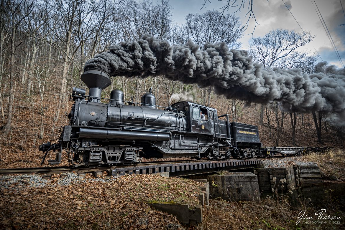 Cass Scenic Railway Shay locomotive number 11, (C-90-3) passes over Leatherbark Run Stream, a tributary of the Greenbrier River, during the Rail Heritage Photography Weekend, at Cass, West Virginia on November 5th, 2022. Leatherbark Run has the distinction of being West Virginia's highest stream.

According to Wikipedia: Cass Scenic Railroad, is an 11-mile (18 km) long heritage railway owned by the West Virginia State Rail Authority and operated by the Durbin and Greenbrier Valley Railroad. The park also includes the former company town of Cass and a portion of the summit of Bald Knob, the highest point on Back Allegheny Mountain.

Founded in 1901 by the West Virginia Pulp and Paper Company (now WestRock), Cass was built as a company town to serve the needs of the men who worked in the nearby mountains cutting spruce and hemlock for the West Virginia Spruce Lumber Company, a subsidiary of WVP&P. At one time, the sawmill at Cass was the largest double-band sawmill in the world. It processed an estimated 1.25 billion board feet (of lumber during its lifetime. In 1901 work started on the 4 ft 8+1⁄2 in standard gauge railroad, which climbs Back Allegheny Mountain. 

The railroad eventually reached a meadow area, now known as Whittaker Station, where a logging camp was established for the immigrants who were building the railroad. The railroad soon reached the top of Gobblers Knob, and then a location on top of the mountain known as 'Spruce'. The railroad built a small town at that location, complete with a company store, houses, a hotel, and a doctor's office. Work soon commenced on logging the red spruce trees, which grew in the higher elevations.

Tech Info: DJI Mavic Air 2S Drone, 22mm, f/2.8, 1/320, ISO 100.

#trainphotography #railroadphotography #trains #railways #dronephotography #trainphotographer #railroadphotographer #jimpearsonphotography #trainsfromtheair #trainsfromadrone