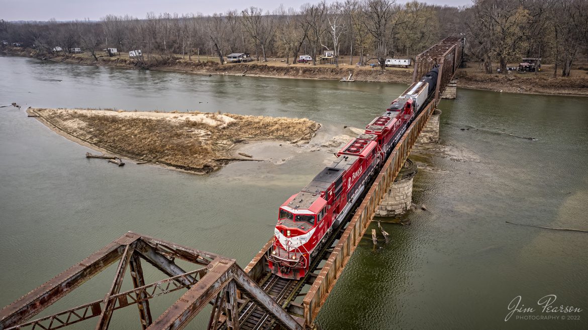 Indiana Railroad 9007 and 9012 lead a local across the Wabash River from Palestine, Illinois as they head south on the Indianapolis Subdivision on November 25th, 2022.

The Indiana Railroad (reporting mark INRD) is a United States Class II railroad, originally operating over former Illinois Central Railroad trackage from Newton, Illinois, to Indianapolis, Indiana, a distance of 155 miles (249 km). 

This line, now known as the Indiana Rail Road's Indianapolis Subdivision, comprises most of the former IC/ICG line from Indianapolis to Effingham, Illinois; Illinois Central successor Canadian National Railway retains the portion from Newton to Effingham. INRD also owns a former Milwaukee Road line from Terre Haute, Indiana, to Burns City, Indiana (site of the Crane Naval Surface Warfare Center), with trackage rights extending to Chicago, Illinois. 

INRD no longer serves Louisville, Kentucky, and the Port of Indiana on the Ohio River at Jeffersonville, Indiana, through a haulage agreement with the Louisville & Indiana Railroad (LIRC).

Tech Info: DJI Mavic Air 2S Drone, RAW, 22mm, f/2.8, 1/640, ISO 130.

#trainphotography #railroadphotography #trains #railways #dronephotography #trainphotographer #railroadphotographer #jimpearsonphotography #indianatrains #indianarailroad