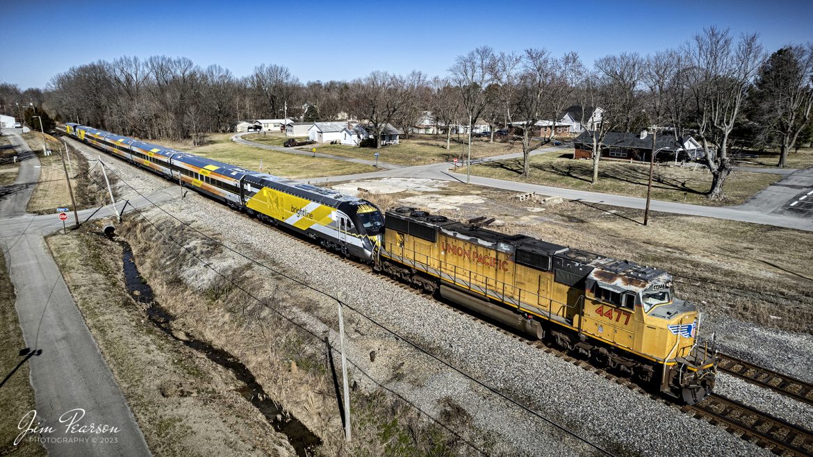 Union Pacific 4477 leads Brightlines Orange 2 trainset as it passes through downtown Hanson, Kentucky on CSX S993 as it heads south on the CSX Henderson subdivision, on February 13th, 2023, on its way to Orlando, Florida. 

According to the GoBrightline Facebook page, This completes our fleet of 10 train sets and is the final of the five new trains for our Orlando extension! We cant wait to welcome Bright Orange 2 to our Vehicle Maintenance Facility in Orlando. Safe travels, and see you soon, Bright Orange 2!

Tech Info: DJI Mavic Air 2S Drone, 22mm, f/2.8, 1/2000, ISO 200.

#trainphotography #railroadphotography #trains #railways #dronephotography #trainphotographer #railroadphotographer #jimpearsonphotography #csx #trainsfromadrone #kentuckytrains #brightlinetrain #csxhendersonsubdivision