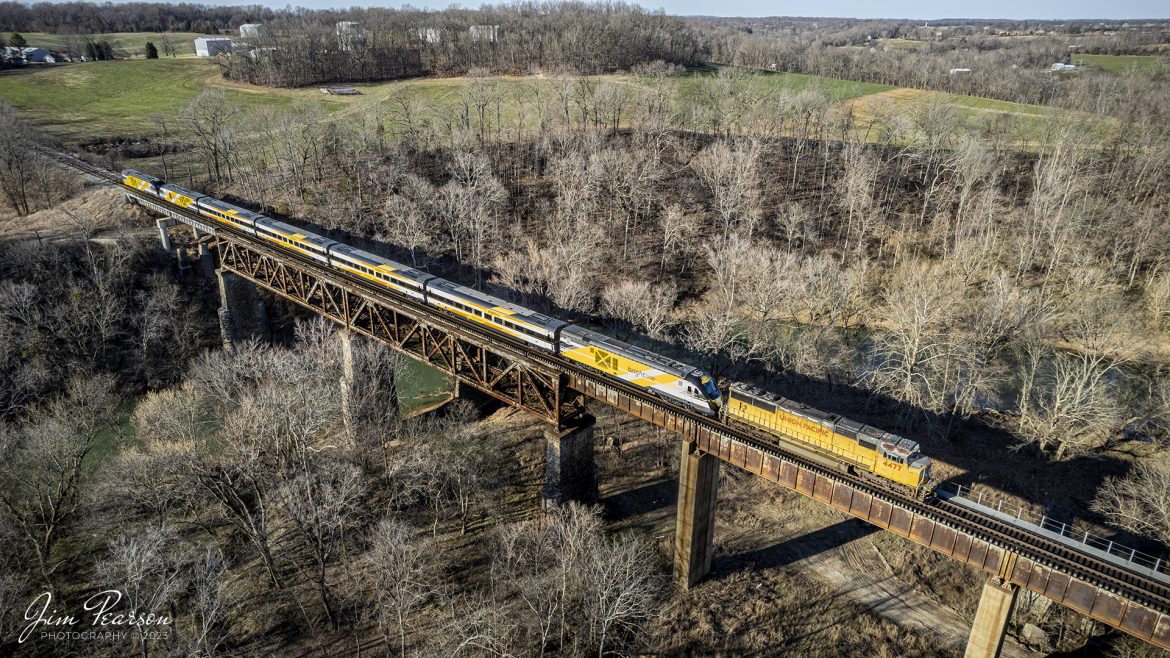 Brightlines Orange 2 trainset rolls over the Red River trestle with Union Pacific 4477 leading the way as it heads south on the CSX Henderson subdivision on CSX S993, at Adams, Tennessee, on February 13th, 2023. 

According to the GoBrightline Facebook page, This completes our fleet of 10 train sets and is the final of the five new trains for our Orlando extension! We cant wait to welcome Bright Orange 2 to our Vehicle Maintenance Facility in Orlando. Safe travels, and see you soon, Bright Orange 2!

Tech Info: DJI Mavic Air 2S Drone, 22mm, f/2.8, 1/1000, ISO 200.

#trainphotography #railroadphotography #trains #railways #dronephotography #trainphotographer #railroadphotographer #jimpearsonphotography #csx #trainsfromadrone #kentuckytrains #brightlinetrain #redriver