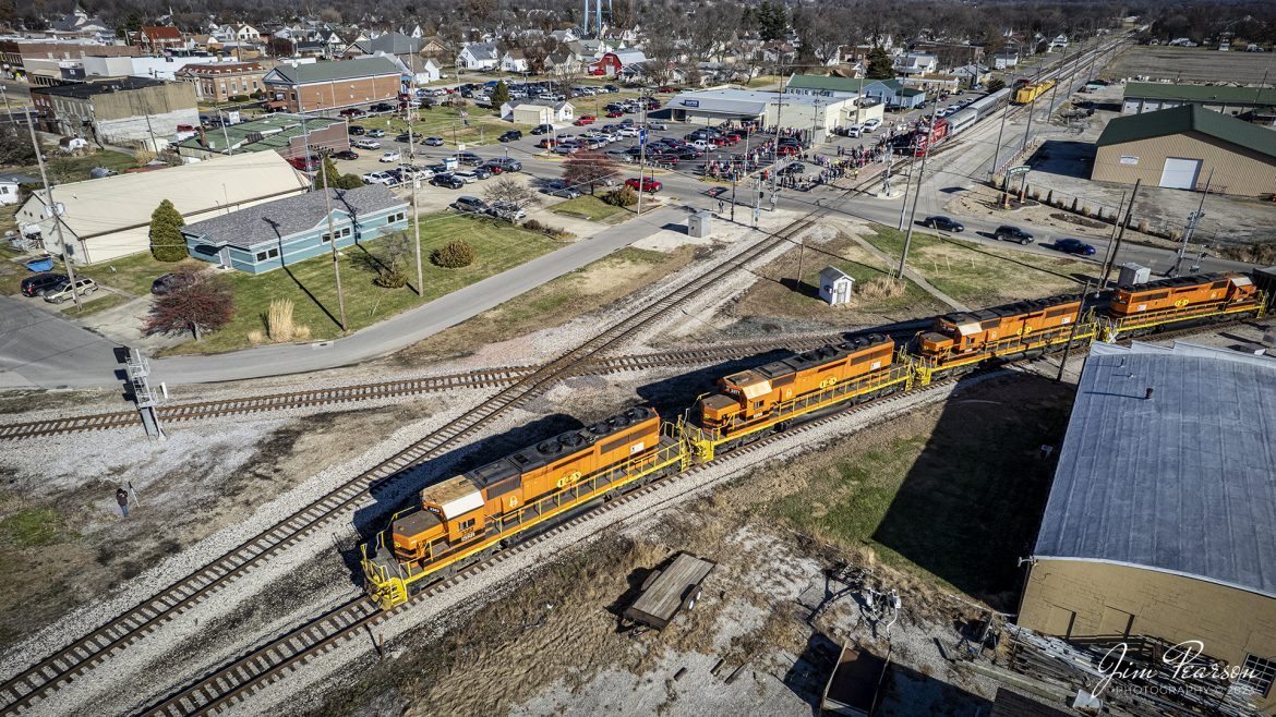 Indiana Southern Railroad locomotive 3382 leads an empty coal train through downtown Linton, Indiana as the Indiana Railroad Santa train sits on the main so Santa can pay a visit to the kids in the community.

The ISRR empty coal train is headed to Bear Run Mine,  just outside Dugger, IN for another load of coal.

According to Wikipedia: The Indiana Southern Railroad (reporting mark ISRR) is a short line or Class III railroad operating in the United States state of Indiana. It began operations in 1992 as a RailTex property and was acquired by RailAmerica in 2000. RailAmerica was acquired by Genesee & Wyoming in December 2012.

Tech Info: DJI Mavic Air 2S Drone, 22mm, f/2.8, 1/2000, ISO 130.

#trainphotography #railroadphotography #trains #railways #dronephotography #trainphotographer #railroadphotographer #jimpearsonphotography