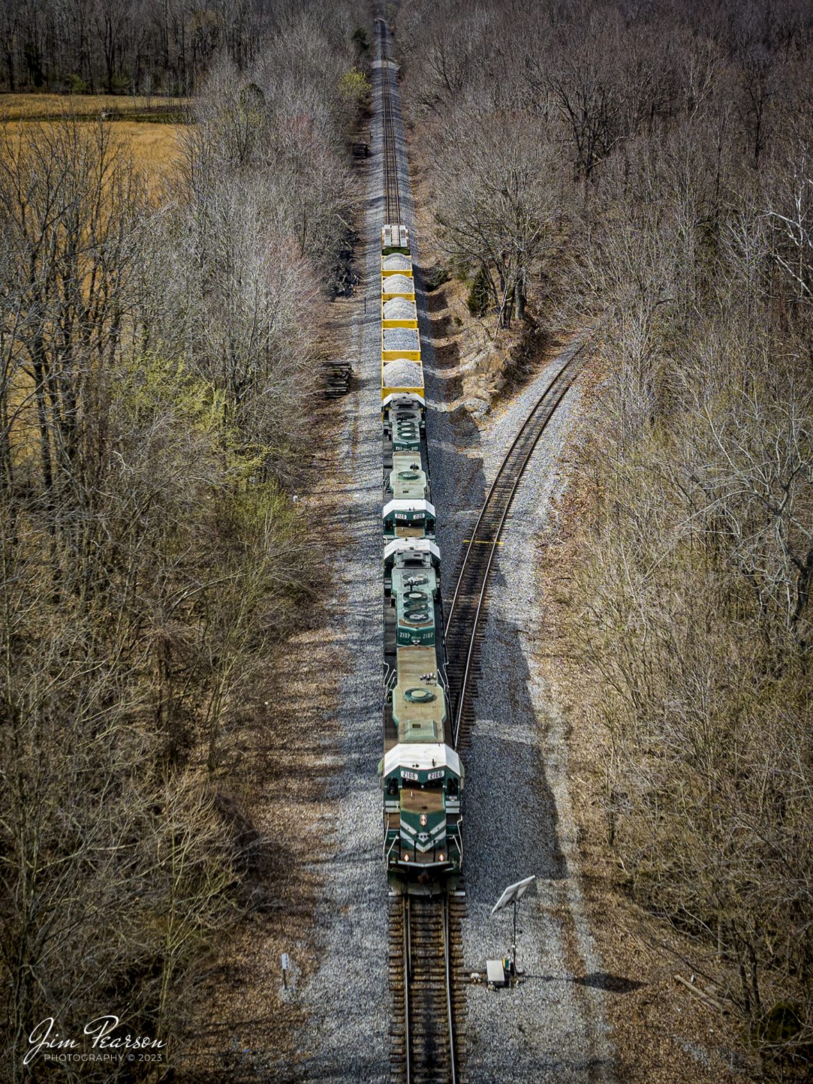 Paducah and Louisville Railway local WW1 passes the Warrior Coal lead as it heads north, approaching West Yard at Madisonville, Ky on March 2nd, 2023, on the Paducah and Louisville Railway with a short string of rock cars, heading for Central City, Ky.

Tech Info: DJI Mavic 3 Classic Drone, RAW, 24mm, f/2.8, 1/1600, ISO 120.

#trainphotography #railroadphotography #trains #railways #dronephotography #trainphotographer #railroadphotographer #jimpearsonphotography #kentuckytrains #pal #paducahandlouisvillerailway #shortlinerailroad #regionalrailroad