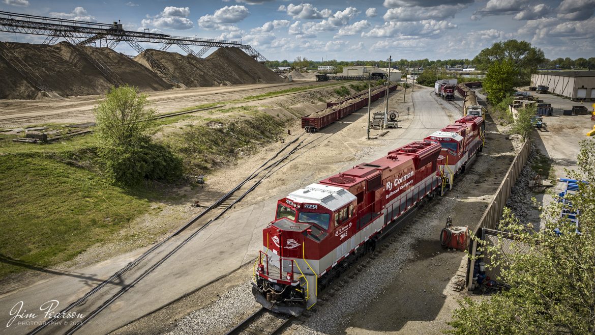Newly painted and refurbished RJ Corman units 2645 and 2648, along with GMTX 9059, sit at Nugent Sand Yard in Louisville, Ky on Saturday afternoon, April 15th, 2023. These first two units were recently acquired by the company from Norfolk Southern and are SD70M locomotives, which are beginning to see road service after coming out of the shops.

Tech Info: DJI Mavic 3 Classic Drone, RAW, 24mm, f/2.8, 1/2000 sec, ISO 100.

#trainphotography #railroadphotography #trains #railways #dronephotography #trainphotographer #railroadphotographer #jimpearsonphotography #kentuckytrains #mavic3classic #drones #trainsfromtheair #trainsfromadrone #RJC #RJCorman #nugentsandcompany #LouisvilleKy
