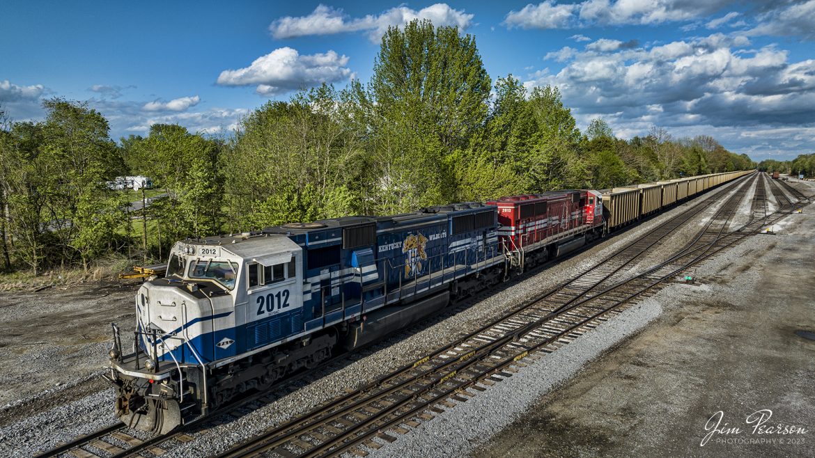 Paducah and Louisville Railway University of Kentucky (2012) and University of Louisville (2013) locomotives head up the southbound Louisville Gas and Electric coal train, as the train sets empty on the Main at West Yards at Madisonville, Ky on April 16th, 2023. Here lately they havent been loading this train on the weekend, so it sat here till Monday morning, when a fresh crew showed up to move it to the Warrior Coal loop for loading.

These two engines were specially painted to honor each schools NCAA basketball wins.

According to Wikipedia: The Paducah & Louisville Railway (reporting mark PAL) is a Class II railroad that operates freight service between Paducah and Louisville, Kentucky. The line is located entirely within the Commonwealth of Kentucky.

The 270-mile (430 km) line was purchased from Illinois Central Gulf Railroad in August 1986. The 223-mile (359 km) main route runs between Paducah and Louisville with branch lines from Paducah to Kevil and Mayfield, Kentucky, and another from Cecilia to Elizabethtown, Kentucky. The PAL interchanges with Burlington Northern Santa Fe (BNSF) and Canadian National (CN), formerly Illinois Central Railroad, in Paducah. In Madisonville, the line interchanges with CSX Transportation (CSXT).

Tech Info: DJI Mavic 3 Classic Drone, RAW, 24mm, f/2.8, 1/1250, ISO 110.

#trainphotography #railroadphotography #trains #railways #dronephotography #trainphotographer #railroadphotographer #jimpearsonphotography #kentuckytrains #mavic3classic #drones #trainsfromtheair#trainsfromadrone #paducahandlouisvillerailway, #pal