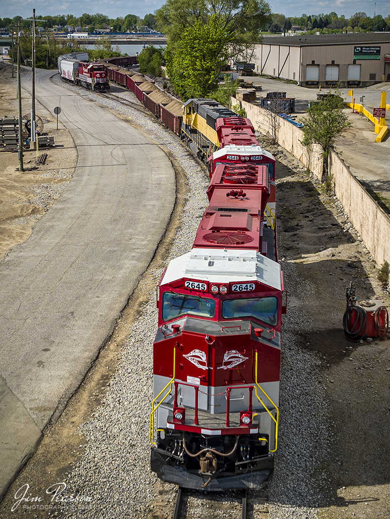 Newly painted and refurbished RJ Corman units 2645 and 2648, along with GMTX 9059, sit at Nugent Sand Yard in Louisville, Ky on Saturday afternoon, April 15th, 2023. These first two units were recently acquired by the company from Norfolk Southern and are SD70M locomotives, which are beginning to see road service after coming out of the shops.

Tech Info: DJI Mavic 3 Classic Drone, RAW, 24mm, f/2.8, 1/2000 sec, ISO 100.

#trainphotography #railroadphotography #trains #railways #dronephotography #trainphotographer #railroadphotographer #jimpearsonphotography #kentuckytrains #mavic3classic #drones #trainsfromtheair #trainsfromadrone #RJC #RJCorman #nugentsandcompany #LouisvilleKy