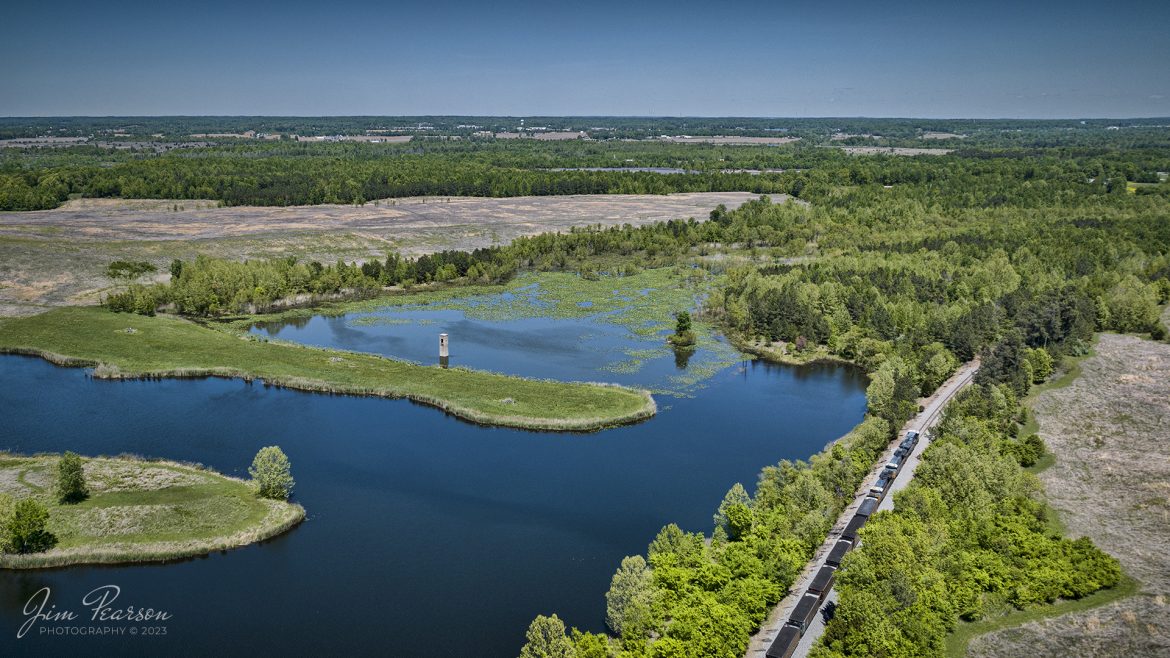 A loaded CSX coal train heads north along the Paducah and Louisville Railway out of Richland, Kentucky on May 3rd, 2023, as they pass Pleasant View Lake towards Madisonville. 

Tech Info: DJI Mavic 3 Classic Drone, RAW, 24mm, f/2.8, 1/2000, ISO 130.

#trainphotography #railroadphotography #trains #railways #dronephotography #trainphotographer #railroadphotographer #jimpearsonphotography #trains #csx #csxrailway #kentuckytrains #mavic3classic #drones #trainsfromtheair #trainsfromadrone #CSXT #CoalTrain #RichlandKy