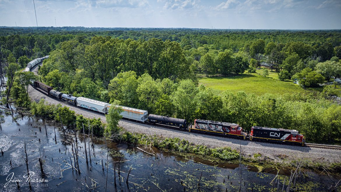 Canadian National Fulton to Paducah local (FUPD) rounds the curve coming into CN's P&I Junction as they head toward the Paducah and Louisville Railway yards at Paducah, Kentucky to perform their daily interchange work, with ex-GTW 6226 leading the way on May 8th, 2023.

Tech Info: DJI Mavic 3 Classic Drone, RAW, 24mm, f/2.8, 1/2500, ISO 170.

#trainphotography #railroadphotography #trains #railways #dronephotography #trainphotographer #railroadphotographer #jimpearsonphotography #BNSFtrains #mavic3classic #drones #trainsfromtheair #trainsfromadrone #coaltrain #CSXT #CalvertCityKy #CSXHonoringLawEnforcement