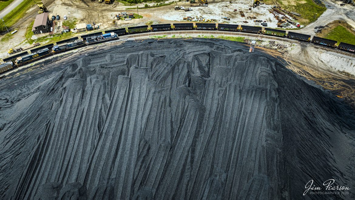CSXT 3194, Honoring our Law Enforcement Locomotive, is dwarfed by the coal pile at Calvert City Terminal, as it leads a loaded coal train into the loop, next to the Tennessee River, at Calvert City, Kentucky, on May 8th, 2023.

Tech Info: DJI Mavic 3 Classic Drone, RAW, 24mm, f/2.8, 1/1000, ISO 130.

#trainphotography #railroadphotography #trains #railways #dronephotography #trainphotographer #railroadphotographer #jimpearsonphotography #BNSFtrains #mavic3classic #drones #trainsfromtheair #trainsfromadrone #coaltrain #CSXT #CalvertCityKy #CSXHonoringLawEnforcement