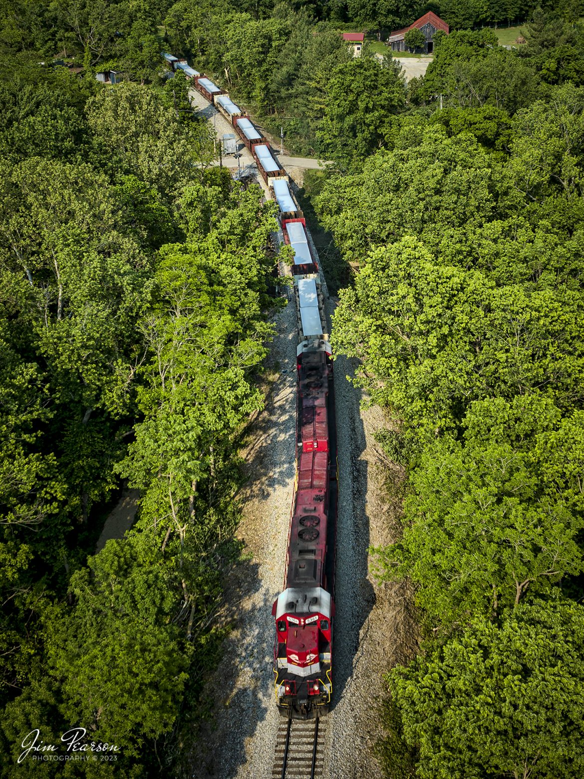 RJ Corman 5361 leads Z545, a train loaded with aluminum ingots towards Louisville, Ky on the CSX LCL Subdivision on May 18th, 2023, as it passes through the countryside at Shelbyville, Ky. This train is also referred to as the ALCAN train and it runs daily between Louisville and Berea, Ky, to and from the Novelis Recycling center at Berea. Alcan used to own the Company and the name most folks use for this train is still Alcan even though Novelis bought them out. 

The Berea plant is one of the worlds largest plants dedicated to aluminum can recycling, and they process approximately 20 percent of the United States used aluminum cans, by melting them down and producing sheet ingots, according to the Novelis website.

Tech Info: DJI Mavic 3 Classic Drone, RAW, 24mm, f/2.8, 1/800, ISO 100.

#trainphotography #railroadphotography #trains #railways #dronephotography #trainphotographer #railroadphotographer #jimpearsonphotography #CSXtrains #mavic3classic #drones #trainsfromtheair #trainsfromadrone #RJCtrain #RJCorman