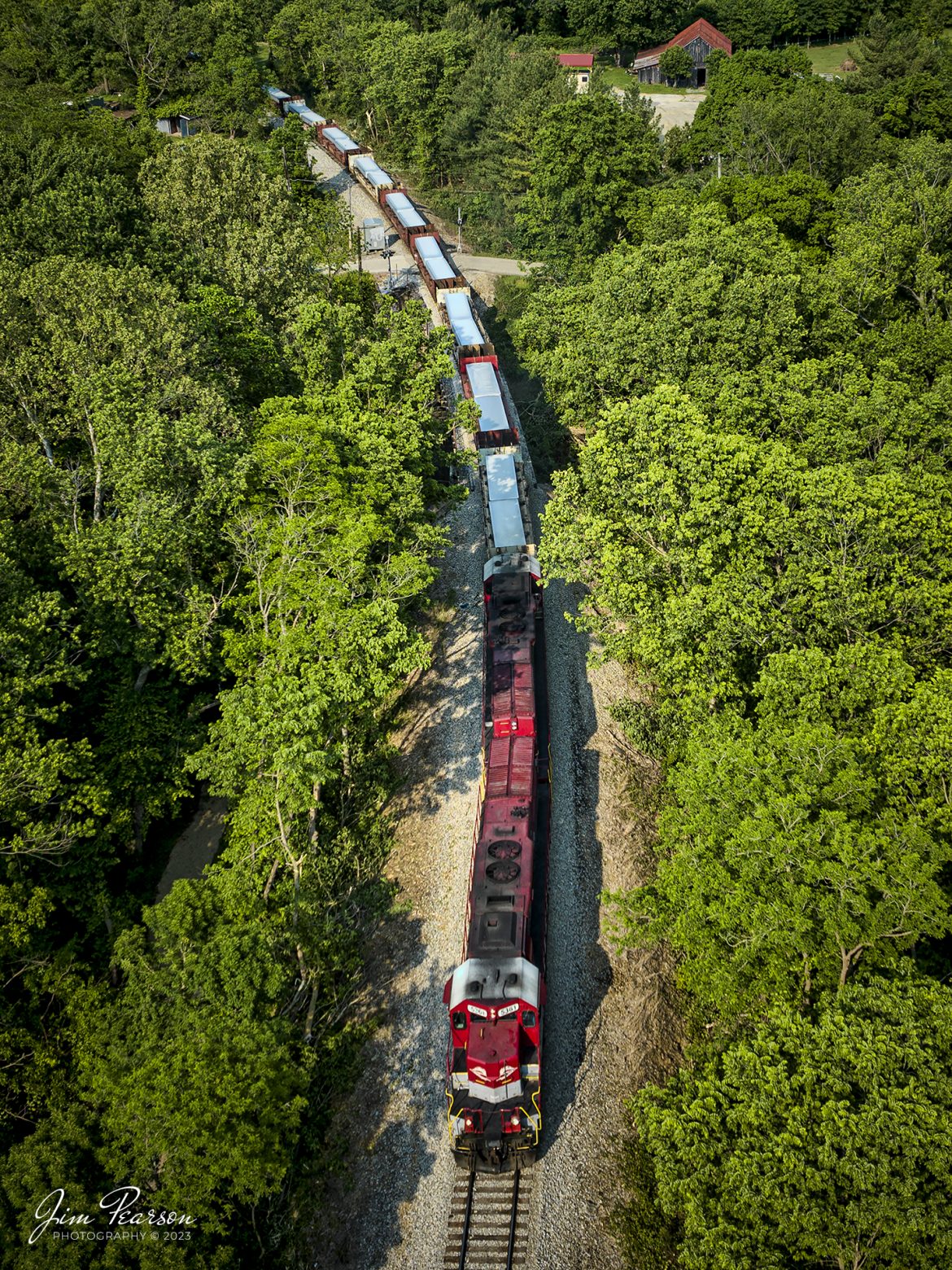 RJ Corman 5361 leads Z545, a train loaded with aluminum ingots towards Louisville, Ky on the CSX LCL Subdivision on May 18th, 2023, as it passes through the countryside at Shelbyville, Ky. This train is also referred to as the ALCAN train and it runs daily between Louisville and Berea, Ky, to and from the Novelis Recycling center at Berea. Alcan used to own the Company and the name most folks use for this train is still Alcan even though Novelis bought them out. 

The Berea plant is one of the worlds largest plants dedicated to aluminum can recycling, and they process approximately 20 percent of the United States used aluminum cans, by melting them down and producing sheet ingots, according to the Novelis website.

Tech Info: DJI Mavic 3 Classic Drone, RAW, 24mm, f/2.8, 1/800, ISO 100.

#trainphotography #railroadphotography #trains #railways #dronephotography #trainphotographer #railroadphotographer #jimpearsonphotography #CSXtrains #mavic3classic #drones #trainsfromtheair #trainsfromadrone #RJCtrain #RJCorman