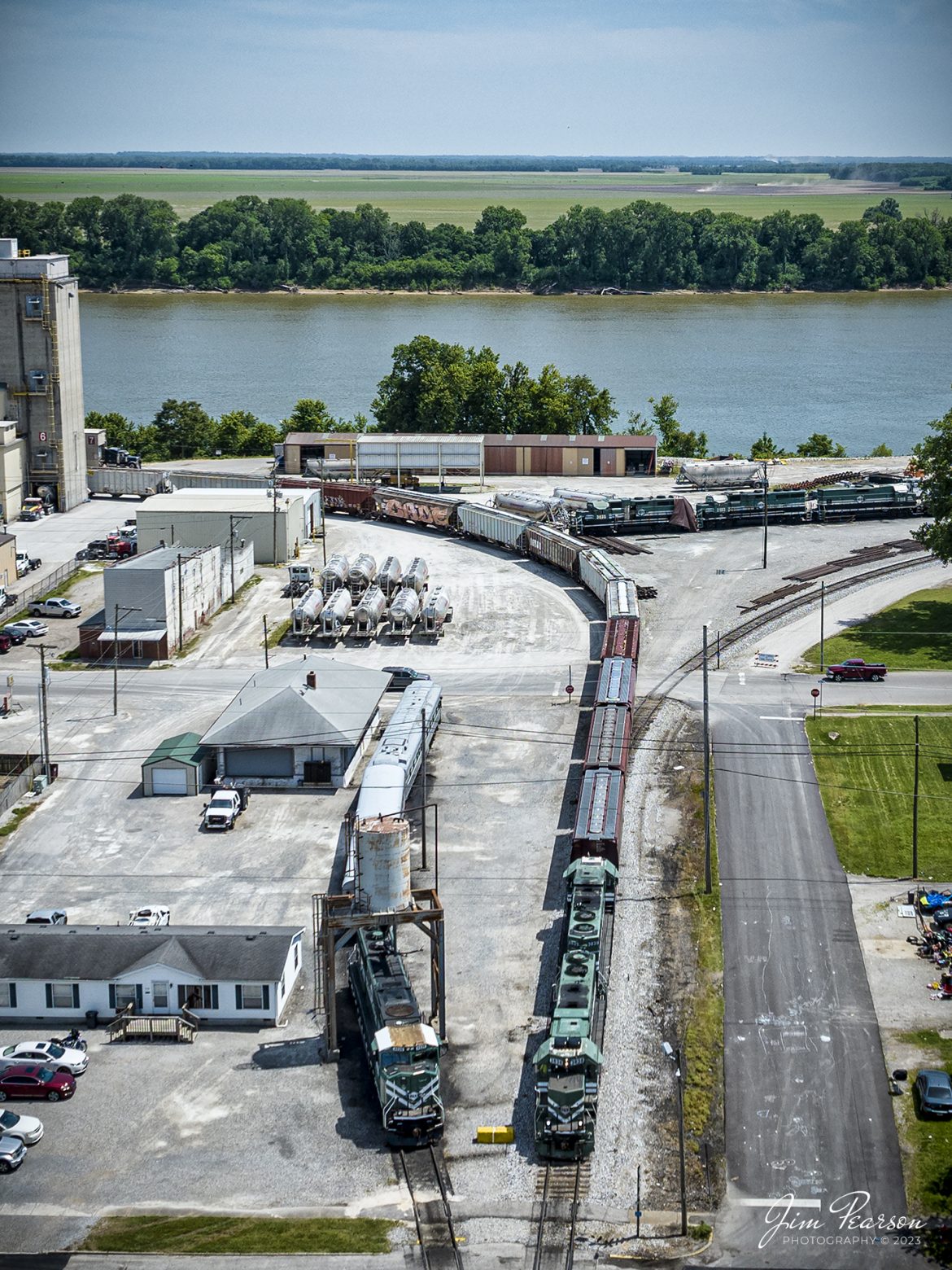 Evansville Western Railway 3838 and 3839 leads the Mount Vernon to Evansville local out of ADM Milling at Mount Vernon, Indiana as they head south to Evansville, IN, on May 22nd, 2023. 

The Evansville Western Railway is a Class III common carrier shortline railroad operating in the southern Illinois and Indiana region. It is one of three regional railroad subsidiaries owned and operated by P&L Transportation. The other company is the Appalachian and Ohio Railroad, located in West Virginia.

Tech Info: DJI Mavic 3 Classic Drone, RAW, 24mm, f/2.8, 1/2000, ISO 100.

#trainphotography #railroadphotography #trains #railways #dronephotography #trainphotographer #railroadphotographer #jimpearsonphotography #CSXtrains #mavic3classic #drones #trainsfromtheair #trainsfromadrone #EVWR #evansvillewesternrailway #trainsfromtheair