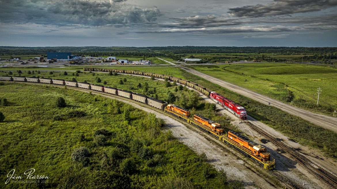 A short Indiana Railroad coal train, EHWBR (East Hiawatha to Bear Run) arrives at Bear Run Mine to pickup a load of coal as it passes a loaded Indiana Southern coal train thats tied down on the inner track of the coal loop, at Dugger, Indiana, on the morning of August 26th, 2023.

According to Wikipedia: The Indiana Railroad (reporting mark INRD) is a United States Class II railroad, originally operating over former Illinois Central Railroad trackage from Newton, Illinois, to Indianapolis, Indiana, a distance of 155 miles (249 km). This line, now known as the Indiana Rail Roads Indianapolis Subdivision, comprises most of the former IC/ICG line from Indianapolis to Effingham, Illinois; Illinois Central successor Canadian National Railway retains the portion from Newton to Effingham.

The company was formed in 1986 by entrepreneur Thomas Hoback, who retired as president and chief executive officer in 2015. CSX Transportation now owns a majority interest in the parent company. The company's executive and administrative offices are in downtown Indianapolis, Indiana.

The Indiana Southern Railroad (reporting mark ISRR) is a short line or Class III railroad operating in the United States state of Indiana. It began operations in 1992 as a RailTex property and was acquired by RailAmerica in 2000. RailAmerica was acquired by Genesee & Wyoming in December 2012.


Tech Info: DJI Mavic 3 Classic Drone, RAW, 24mm, f/2.8, 1/1600, ISO 110.

#trainphotography #railroadphotography #trains #railways #dronephotography #trainphotographer #railroadphotographer #jimpearsonphotography #trains #mavic3classic #drones #trainsfromtheair #trainsfromadrone #INRD #ISRR #Indianatrains #coaltrains