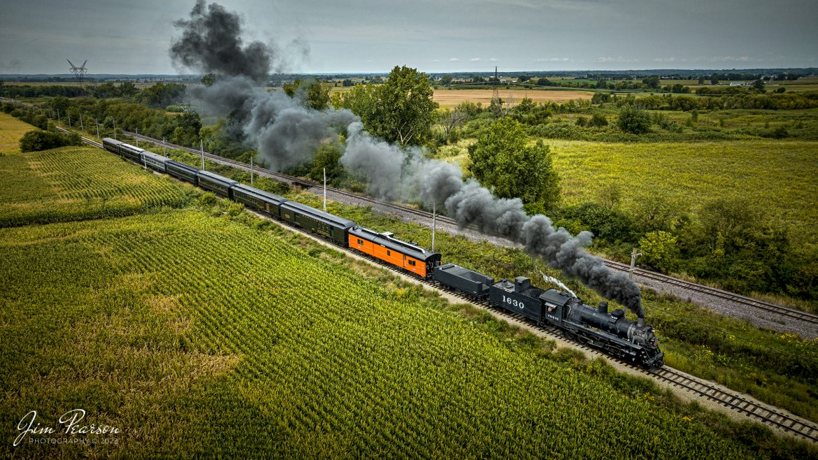 Steam locomotive Frisco 1630 makes its way east through the countryside after leaving the Illinois Railway Museum (IRM) on a passenger, during their 70th anniversary weekend in Union, Illinois on September 16th, 2023. 

According to IRM website: St. Louis  San Francisco Railroad (Frisco) 1630 is the museums most famous steam engine. A Russian Decapod, it was built in 1918 for export to Russia but was embargoed when the Bolshevik Revolution took place. Instead, the newly completed engine was sold to the Frisco, which used it in both freight and passenger service into the 1950s. The Frisco later sold it to Eagle-Picher Mining, where it saw use hauling freight and aggregate trains until the mid-1960s. It arrived at the IRM in 1967.

#trainphotography #railroadphotography #trains #railways #dronephotography #trainphotographer #railroadphotographer #jimpearsonphotography #trains #mavic3classic #drones #trainsfromtheair #trainsfromadrone #IllinoisRailwayMuseum #IllinoisTrains #SteamTrains