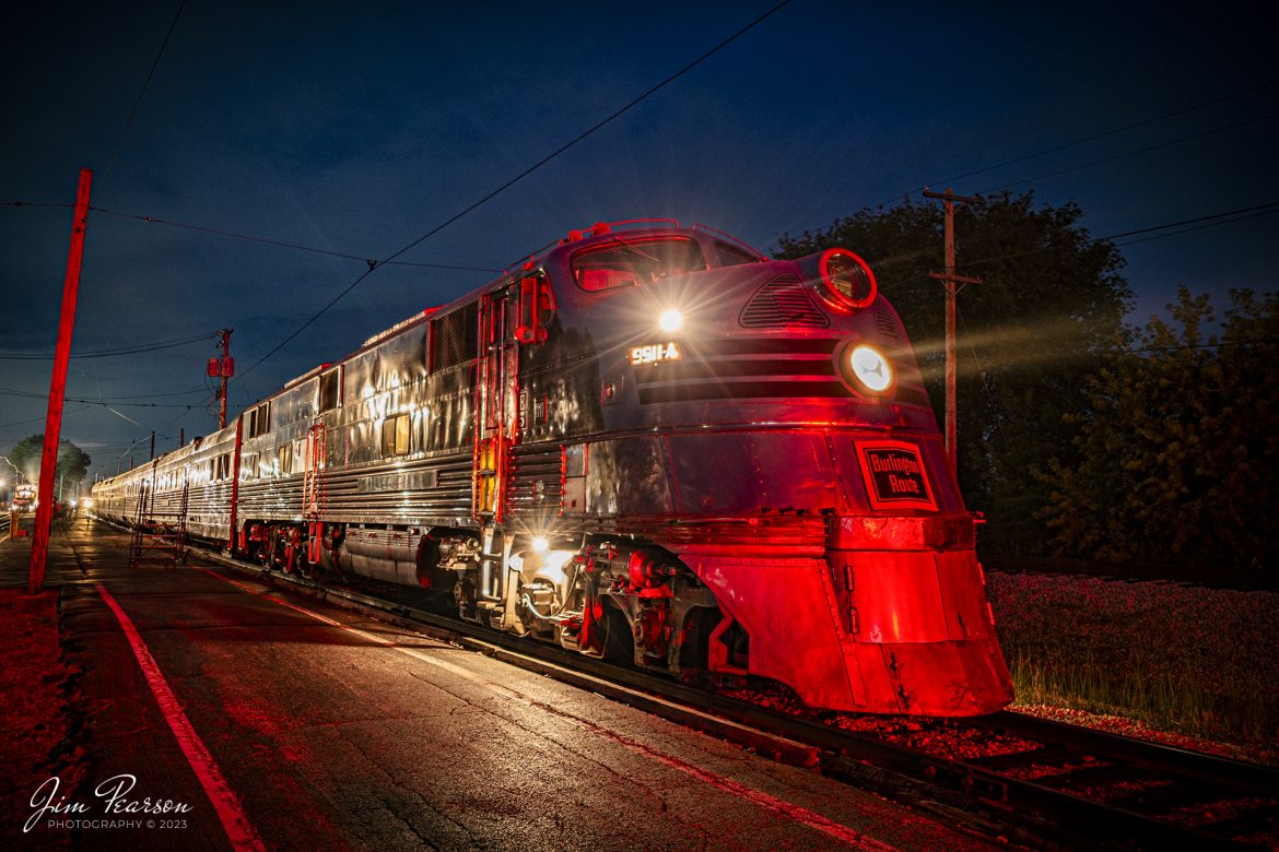 Bathed in the light from a red signal, Chicago Burlington & Quincy Railroad Nebraska Zephyr Silver Pilot sits at the depot at the Illinois Railway Museum (IRM), Union, Illinois on September 16th, 2023, as it waits for its next night run as part of the museums 70th Anniversary celebration. The IRM ran trains continuously from 11am on Saturday until 5pm Sunday during the event.

According to the IRM website: The Nebraska Zephyr is the most famous train at the Illinois Railway Museum. It is an articulated streamlined train built entirely of stainless steel. The train is known as the Train of the Goddesses because each of its five cars is named after a classical deity. It is the only complete Zephyr train from the Chicago Burlington & Quincy Railroad in operation today.

When it was built, the Nebraska Zephyr was pulled by a two-unit set of shovel nose diesels. In later years it was commonly hauled by stainless steel E5 passenger diesels, and today the train is still hauled by the last surviving E5, CB&Q 9911A Silver Pilot. The train set itself consists of the following five cars:

Tech Info: Nikon D800, Nikon 10-24 @ 16mm, f/4, 15 seconds, ISO 100.

#trainphotography #railroadphotography #trains #railways #trainphotographer #railroadphotographer #jimpearsonphotography #NebraskaZephyr #IllinoisRailwayMuseum #IllinoisTrains #TrainsAtNight