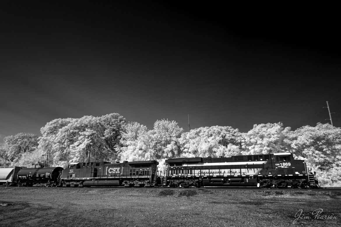 In this weeks Saturday Infrared photo, I caught the CSX Chesapeake & Ohio Heritage unit 1869 as it led CSX M500 at Howell Yard in Evansville, Indiana on September 28th, 2023, as it headed north on the Evansville Terminal Subdivision. This was the fifth CSX Heritage Unit Ive caught of the six theyve released. Now Im waiting for the L&N unit to get close to me!

I really didnt expect to catch this unit as it was supposed to pass through yesterday during the late afternoon, but they ran into problems with their DPU at Guthrie, Ky and had to leave their train there and run to Casky Yard in Hopkinsville, Ky for a replacement. All said and done the train passed through my area in the dead of night.

I got a heads up from a friend the next morning that it was still at Howell and a new crew was starting to do their drop off and pickup there. I figured that one of the hot intermodals coming south would keep it in the yard awhile and so I decided to make the one-hour drive north to see if I could catch them and I got there just when he was finishing up his work! I chased him all the way to Princeton, Indiana on the CE&D Subdivision and got several nice shots which Ill be posting in the weeks ahead! 

According to the CSX Website: A locomotive commemorating the proud history of the Chesapeake and Ohio Railway has entered service as the fifth in the CSX heritage series celebrating the lines that came together to form the modern railroad.
 
Numbered CSX 1869 in honor of the year the C&O was formed in Virginia from several smaller railroads, the newest heritage locomotive sports a custom paint design that includes todays CSX colors on the front of the engine and transitions to a paint scheme inspired by 1960s era C&O locomotives on the rear two-thirds.

The C&O Railway was a major line among North American freight and passenger railroads for nearly a century before becoming part of the Chessie System in 1972 and eventually merging into the modern CSX. In 1970, the C&O included more than 5,000 route miles of track stretching from Newport News, Virginia, to Chicago and the Great Lakes. 
 
Designed and painted at CSXs locomotive shop in Waycross, Georgia, the C&O unit will join four other commemorative units in revenue service on CSXs 20,000-mile rail network. 
 
The heritage series is reinforcing employee pride in the history of the railroad that continues to move the nations economy with safe, reliable and sustainable rail-based transportation services.

Tech Info: Fuji XT-1, RAW, Converted to 720nm B&W IR, Nikon 10-24 @ 12mm, f/5.6, 1/400, ISO 400.

#trainphotography #railroadphotography #trains #railways #jimpearsonphotography #infraredtrainphotography #infraredphotography #trainphotographer #railroadphotographer #CSXHeritageUnit #EvansvilleIN #C&OCommemorativeLocomotive