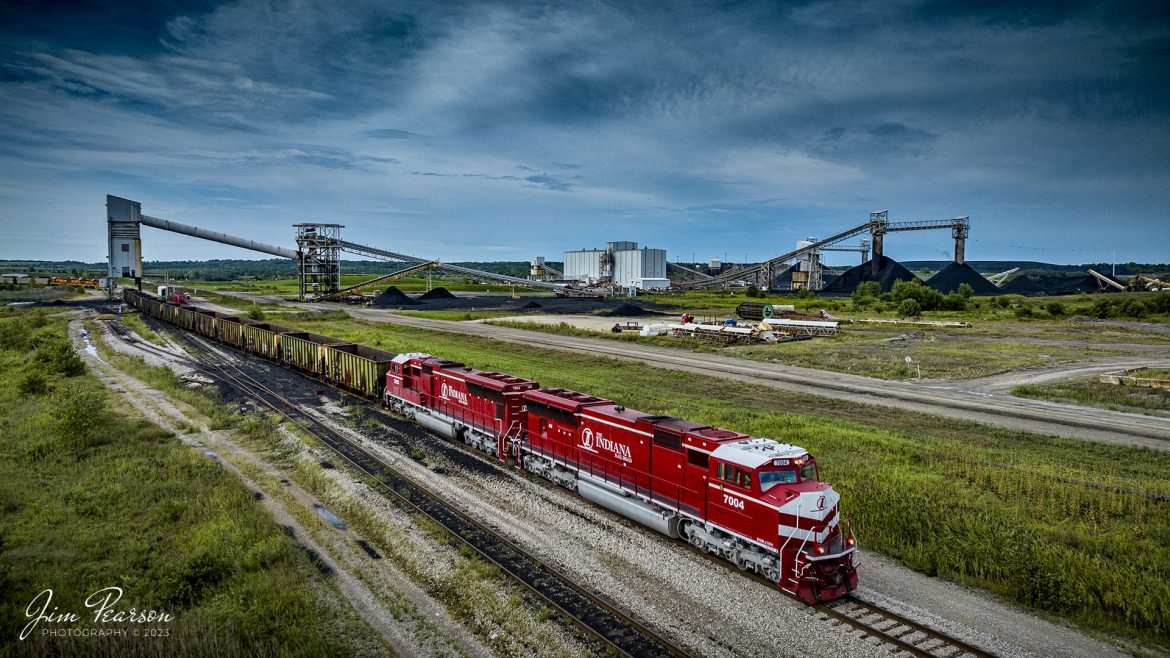 A short Indiana Railroad coal train, EHWBR (Empty Hiawatha to Bear Run) loads at Bear Run Mine, at Dugger, Indiana, on August 26th, 2023. The short load of 14 cars is destined to a customer somewhere in Wisconsin.

According to Wikipedia: The Indiana Railroad (reporting mark INRD) is a United States Class II railroad, originally operating over former Illinois Central Railroad trackage from Newton, Illinois, to Indianapolis, Indiana, a distance of 155 miles (249 km). This line, now known as the Indiana Rail Roads Indianapolis Subdivision, comprises most of the former IC/ICG line from Indianapolis to Effingham, Illinois; Illinois Central successor Canadian National Railway retains the portion from Newton to Effingham.

The company was formed in 1986 by entrepreneur Thomas Hoback, who retired as president and chief executive officer in 2015. CSX Transportation now owns a majority interest in the parent company. The company's executive and administrative offices are in downtown Indianapolis, Indiana.

Tech Info: DJI Mavic 3 Classic Drone, RAW, 24mm, f/2.8, 1/2500, ISO 180.

#trainphotography #railroadphotography #trains #railways #dronephotography #trainphotographer #railroadphotographer #jimpearsonphotography #trains #mavic3classic #drones #trainsfromtheair #trainsfromadrone #coaltrain #INRD #bearrunmine #DuggerIndiana