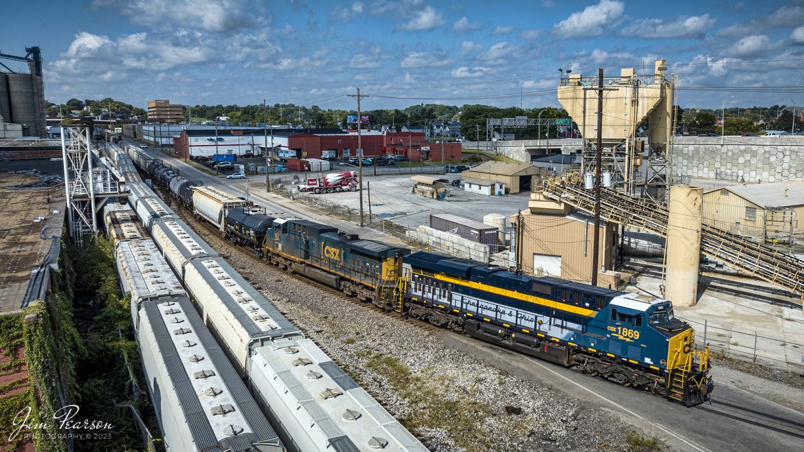 CSX Chesapeake & Ohio Heritage unit 1869 leads CSX M500 as it passes through the Ohio Street Crossing, on the way north at Evansville, Indiana on September 28th, 2023, on the Evansville Terminal Subdivision. 

According to the CSX Website: A locomotive commemorating the proud history of the Chesapeake and Ohio Railway has entered service as the fifth in the CSX heritage series celebrating the lines that came together to form the modern railroad.

Numbered CSX 1869 in honor of the year the C&O was formed in Virginia from several smaller railroads, the newest heritage locomotive sports a custom paint design that includes todays CSX colors on the front of the engine and transitions to a paint scheme inspired by 1960s era C&O locomotives on the rear two-thirds.

The C&O Railway was a major line among North American freight and passenger railroads for nearly a century before becoming part of the Chessie System in 1972 and eventually merging into the modern CSX. In 1970, the C&O included more than 5,000 route miles of track stretching from Newport News, Virginia, to Chicago and the Great Lakes. 

Designed and painted at CSXs locomotive shop in Waycross, Georgia, the C&O unit will join four other commemorative units in revenue service on CSXs 20,000-mile rail network. 

The heritage series is reinforcing employee pride in the history of the railroad that continues to move the nations economy with safe, reliable, and sustainable rail-based transportation services.

Tech Info: DJI Mavic 3 Classic Drone, RAW, 22mm, f/2.8, 1/2500, ISO 100.

#trainphotography #railroadphotography #trains #railways #jimpearsonphotography #trainphotographer #railroadphotographer #CSXHeritageUnit #HaubstadtIN #C&OCommemorativeLocomotive