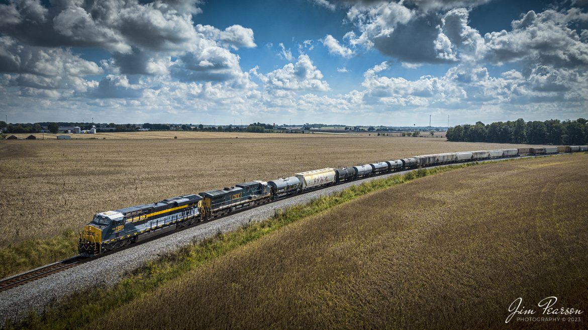 CSX Chesapeake & Ohio Heritage unit 1869 as it leads CSX M500 as it passes through St. James Curve at Haubstadt, Indiana on September 28th, 2023, as it headed north on the CE&D Subdivision. 

According to the CSX Website: A locomotive commemorating the proud history of the Chesapeake and Ohio Railway has entered service as the fifth in the CSX heritage series celebrating the lines that came together to form the modern railroad.
 
Numbered CSX 1869 in honor of the year the C&O was formed in Virginia from several smaller railroads, the newest heritage locomotive sports a custom paint design that includes todays CSX colors on the front of the engine and transitions to a paint scheme inspired by 1960s era C&O locomotives on the rear two-thirds.

The C&O Railway was a major line among North American freight and passenger railroads for nearly a century before becoming part of the Chessie System in 1972 and eventually merging into the modern CSX. In 1970, the C&O included more than 5,000 route miles of track stretching from Newport News, Virginia, to Chicago and the Great Lakes. 
 
Designed and painted at CSXs locomotive shop in Waycross, Georgia, the C&O unit will join four other commemorative units in revenue service on CSXs 20,000-mile rail network. 
 
The heritage series is reinforcing employee pride in the history of the railroad that continues to move the nations economy with safe, reliable, and sustainable rail-based transportation services.

Tech Info: DJI Mavic 3 Classic Drone, RAW, 22mm, f/2.8, 1/4000, ISO 160.

#trainphotography #railroadphotography #trains #railways #jimpearsonphotography #trainphotographer #railroadphotographer #CSXHeritageUnit #HaubstadtIN #C&OCommemorativeLocomotive