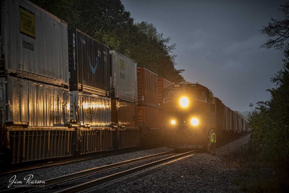 The conductor on G419, with the latest CSX Heritage Unit L&N 1850 leading his loaded grain train, conducts a roll-by inspection on hot intermodal I028 at the south end of the siding at Slaughters, Kentucky on October 5th, 2023, on the Henderson Subdivision.

According to CSXT: CSX has introduced the sixth locomotive in its heritage series, a freshly painted unit honoring the Louisville & Nashville Railroad. Designated CSX 1850, the locomotive will be placed into service, carrying the L&N colors across the 20,000-mile CSX network.

The paint scheme was designed and applied at the CSX Locomotive Shop in Waycross, Georgia, which has produced all six units in the heritage series celebrating the lines that came together to form the modern CSX. Like the other heritage locomotives, the L&N unit combines the heritage railroads iconic logo and colors on the rear two-thirds of the engine with todays CSX colors and markings on the cab end.

Chartered by the State of Kentucky in 1850, the L&N grew into a vital transportation link between the Gulf Coast and the nations heartland. The railroad was absorbed by the Seaboard Coast Line Railroad, which subsequently became part of the Chessie System and, ultimately, todays CSX.

The CSX heritage series is reinforcing employee pride in the history of the railroad that continues to move the nations economy with safe, reliable, and sustainable rail-based transportation services.

Tech Info: DJI Mavic 3 Classic Drone, RAW, 22mm, f/8, 1/60, ISO 360.

#trainphotography #railroadphotography #trains #railways #jimpearsonphotography #trainphotographer #railroadphotographer #CSXHeritage #SlaughtersKy #dronephoto #trainsfromadrone #KyTrains