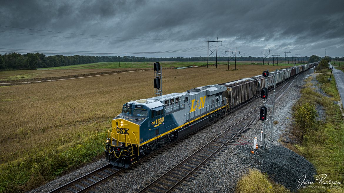 CSX Louisville and Nashville Heritage Unit 1850 leads loaded grain train G419, as it heads south under stormy skies, approaching the south end of Kings Siding at Ft. Branch, Indiana, on October 5th, 2023, on the CE&D Subdivision, trackage that used to belong to the L&N.

According to CSXT: CSX has introduced the sixth locomotive in its heritage series, a freshly painted unit honoring the Louisville & Nashville Railroad. Designated CSX 1850, the locomotive will be placed into service, carrying the L&N colors across the 20,000-mile CSX network.

The paint scheme was designed and applied at the CSX Locomotive Shop in Waycross, Georgia, which has produced all six units in the heritage series celebrating the lines that came together to form the modern CSX. Like the other heritage locomotives, the L&N unit combines the heritage railroads iconic logo and colors on the rear two-thirds of the engine with todays CSX colors and markings on the cab end.

Chartered by the State of Kentucky in 1850, the L&N grew into a vital transportation link between the Gulf Coast and the nations heartland. The railroad was absorbed by the Seaboard Coast Line Railroad, which subsequently became part of the Chessie System and, ultimately, todays CSX.

The CSX heritage series is reinforcing employee pride in the history of the railroad that continues to move the nations economy with safe, reliable, and sustainable rail-based transportation services.

Tech Info: DJI Mavic 3 Classic Drone, RAW, 22mm, f/8, 1/240, ISO 160.

#trainphotography #railroadphotography #trains #railways #jimpearsonphotography #trainphotographer #railroadphotographer #CSXHeritage #FtBranchIndiana #dronephoto #trainsfromadrone #IndianaTrains #CSXLandNHeritageunit