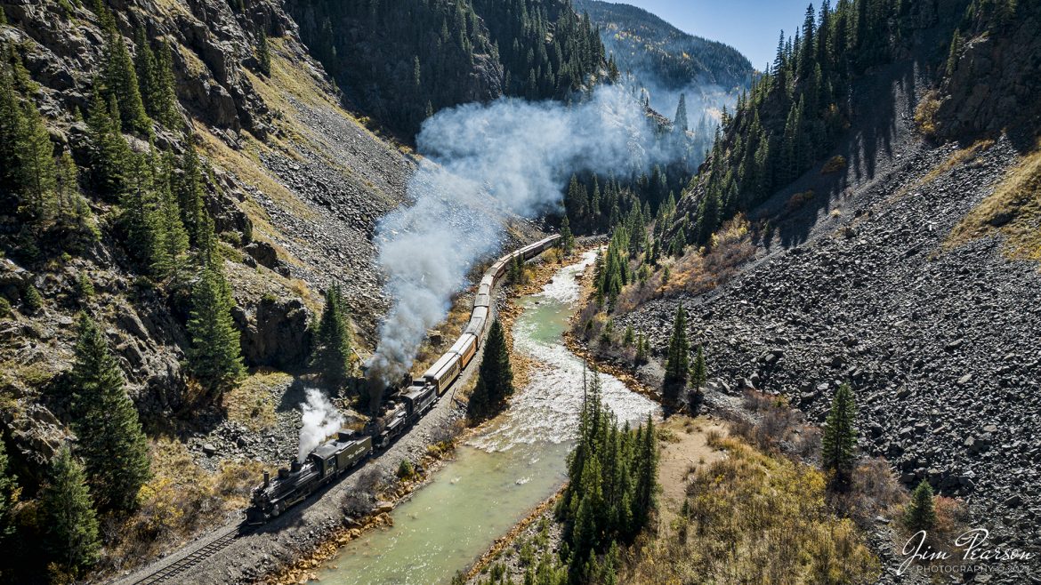 Denver and Rio Grande Western double header steam locomotives 473 and 493 pull one of several daily passenger trains south through Deadwood Gulch, as they approach Silverton, Colorado on October 15th, 2023.

According to Wikipedia: The Durango and Silverton Narrow Gauge Railroad, often abbreviated as the D&SNG, is a 3 ft (914 mm) narrow-gauge heritage railroad that operates on 45.2 mi (72.7 km) of track between Durango and Silverton, in the U.S. state of Colorado. The railway is a federally designated National Historic Landmark and was also designated by the American Society of Civil Engineers as a National Historic Civil Engineering Landmark in 1968.

Tech Info: DJI Mavic 3 Classic Drone, RAW, 22mm, f/2.8, 1/1250, ISO 180.

railroad, railroads train, trains, best photo. sold photo, railway, railway, sold train photos, sold train pictures, steam trains, rail transport, railroad engines, pictures of trains, pictures of railways, best train photograph, best photo, photography of trains, steam train photography, sold picture, best sold picture, Jim Pearson Photography, Durango and Silverton Railroad