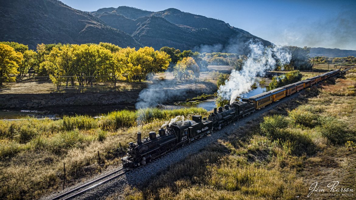 Denver and Rio Grande Western double header steam locomotives 473 and 493 pull south out of Durango with a daily passenger train, bound for Silverton, Colorado on October 15th, 2023.

According to Wikipedia: The Durango and Silverton Narrow Gauge Railroad, often abbreviated as the D&SNG, is a 3 ft (914 mm) narrow-gauge heritage railroad that operates on 45.2 mi (72.7 km) of track between Durango and Silverton, in the U.S. state of Colorado. The railway is a federally designated National Historic Landmark and was also designated by the American Society of Civil Engineers as a National Historic Civil Engineering Landmark in 1968.

Tech Info: DJI Mavic 3 Classic Drone, RAW, 22mm, f/2.8, 1/2000, ISO 170.

railroad, railroads train, trains, best photo. sold photo, railway, railway, sold train photos, sold train pictures, steam trains, rail transport, railroad engines, pictures of trains, pictures of railways, best train photograph, best photo, photography of trains, steam train photography, sold picture, best sold picture, Jim Pearson Photography, Durango and Silverton Railroad, trains from a drone