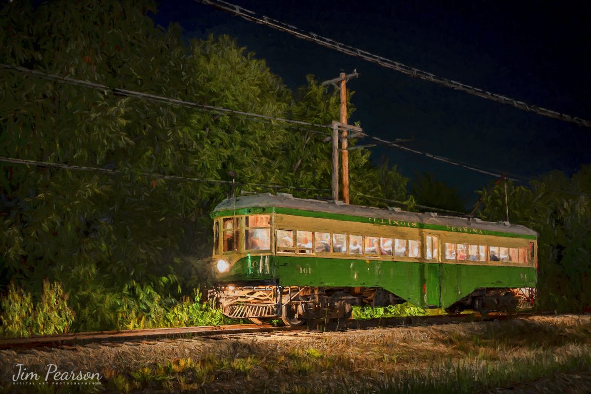 Digital Photo Art - Illinois Terminal interurban coach 101 sits on the main next to the depot at the Illinois Railway Museum (IRM) in the dark on September 16th, 2023, as it waits for a green signal to proceed at Union Illinois, during the IRM 70th Anniversary celebration where the museum ran trains continuously from 11am Saturday morning to 5pm Sunday afternoon, which gave a rare opportunity to photograph much of their equipment during nighttime hours.

According to the IRM website: Illinois Terminal 101 is a rare example of a center-entrance interurban coach. It operated its entire service life between St. Louis, Missouri and Alton, Illinois. These cars were built for high-speed operation and were known as Yellowhammers and Alton High-speeds. The car has been restored to its appearance in the mid-1950s.

Tech Info: Nikon D800, RAW, Nikon 10-24 @24mm, f/4.5, 30 Seconds, ISO 100.

#trainphotography #railroadphotography #trains #railways #dronephotography #trainphotographer #railroadphotographer #jimpearsonphotography #NikonD800 #IllinoisRailwayMuseum #trainsinbadweather #illinoistrains #interurbancoach #streetcars #trainsatnight