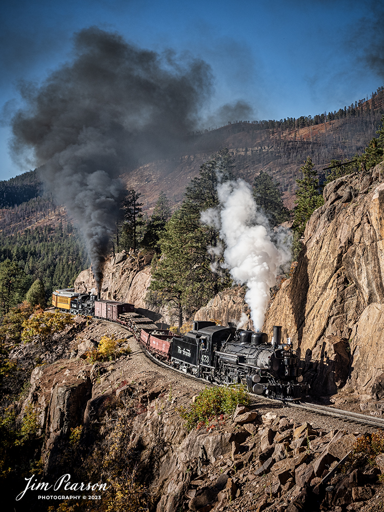 Durango and Silverton Narrow Gauge steam locomotive D&RGW 473 pulls a K-28 100th Anniversary Special with D&RGW 476 as a mid-train helper through the Repeating Curves at MP 472.2, along the Animas River, between Durango and Silverton, Colorado, on October 16th, 2023.

According to Wikipedia: The Durango and Silverton Narrow Gauge Railroad, often abbreviated as the D&SNG, is a 3 ft (914 mm) narrow-gauge heritage railroad that operates on 45.2 mi (72.7 km) of track between Durango and Silverton, in the U.S. state of Colorado. The railway is a federally designated National Historic Landmark and was also designated by the American Society of Civil Engineers as a National Historic Civil Engineering Landmark in 1968.

Tech Info: Nikon D810, RAW, Sigma 24-70 @ 24mm, f/5.6, 1/640, ISO 160.

railroad, railroads train, trains, best photo. sold photo, railway, railway, sold train photos, sold train pictures, steam trains, rail transport, railroad engines, pictures of trains, pictures of railways, best train photograph, best photo, photography of trains, steam, train photography, sold picture, best sold picture, Jim Pearson Photography, Durango and Silverton Narrow Guage Railroad, steam train, DRGWRR