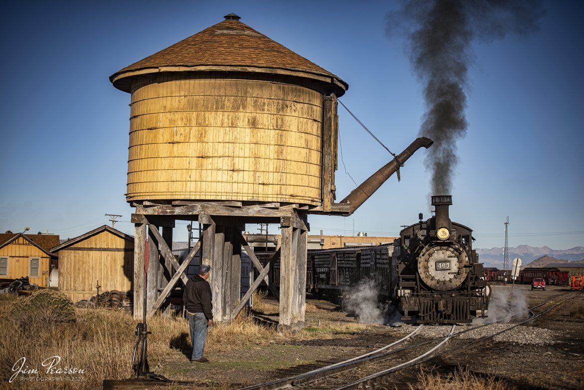 Cumbres & Toltec Scenic Railroad steam locomotive D&RGW 463 approaches the water tower at Antonito, Colorado with a freight train, during a photo charter by Dak Dillon Photography on October 19th, 2023, as a switchman stands by to re-align the switch after he passes.

According to their website: the Cumbres & Toltec Scenic Railroad is a National Historic Landmark.  At 64-miles in length, it is the longest, the highest and most authentic steam railroad in North America, traveling through some of the most spectacular scenery in the Rocky Mountain West.

Owned by the states of Colorado and New Mexico, the train crosses state borders 11 times, zigzagging along canyon walls, burrowing through two tunnels, and steaming over 137-foot Cascade Trestle. All trains steam along through deep forests of aspens and evergreens, across high plains filled with wildflowers, and through a rocky gorge of remarkable geologic formations. Deer, antelope, elk, fox, eagles and even bear are frequently spotted on this family friendly, off-the grid adventure.

According to History Colorado Website: Built in 1903 by the Baldwin Locomotive Works of Philadelphia, Engine No. 463 is one of only two remaining locomotives of the K-27 series originally built for and operated by the Denver & Rio Grande Western Railroad.

The K-27 series was a departure from the design most prevalent on Colorado’s narrow-gauge lines, resulting in a locomotive with one and one-half times more power.  The arrival of this series marked a significant turning point in the operation of the D&RGW’s narrow gauge lines that was to remain in effect until the end of Class I narrow gauge steam locomotion in 1968.  The Friends of the Cumbres & Toltec Scenic Railroad restored the engine to operating condition.

Tech Info: Nikon D810, RAW, Nikon 10-24 @ 70mm, f/4.5, 1/2000, ISO 110.

#trainphotographer #railroadphotographer #jimpearsonphotography #NikonD810 #digitalphotoart #steamtrain #ColoradoSteamTrain #ctsrr