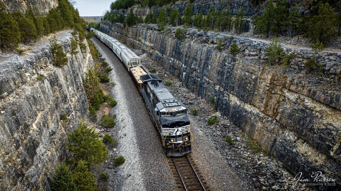 Norfolk Southern 4124 leads NS 168 west through the cut at Tunnel Hill, just west of Ramsey, Indiana on November 4th, 2023, as it heads west on the NS Southern East District. This rock cut was made close to the old existing tunnel where the trains used to run.

Tech Info: DJI Mavic 3 Classic Drone, RAW, 22mm, f/8, 1/240, ISO 100.

#trainphotography #railroadphotography #trains #railways #jimpearsonphotography #trainphotographer #railroadphotographer #NSRailway #dronephoto #trainsfromadrone #IndianaTrains #ramseyIn #TunnelHill #nseastdistrict