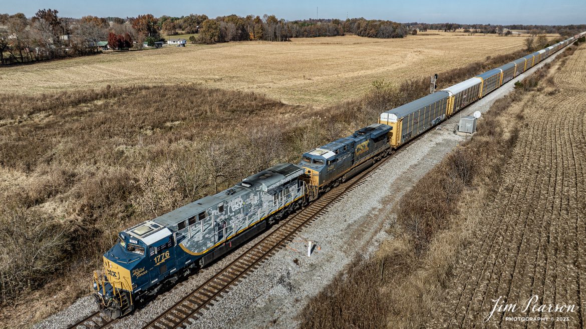 It sure was nice of CSX to send CSXT 1776 Spirit of Our Armed Forces locomotive heading south on Veteran’s Day, November 11th, 2023. Here I captured it as it passed the signals at the north end of the siding at Slaughters, as it made its way south on the CSX Henderson Subdivision. 

According to a press release from CSXT, ES44AH locomotive No. 1776, dubbed “The Spirit of Our Armed Forces,” was unveiled 0n April 30, 2019 at the railroad’s Huntington Heavy Repair shops in West Virginia.
No. 1776, renumbered from No. 3112, wears a combination standard CSX scheme on its cab and a highly detailed digital camouflage paint scheme on its long hood which adorns CSX’s new “Pride in Service” logo. The seals of the five-armed services branches are spread across the rear of the engine’s radiators, and logos for several support organizations for veterans and veterans’ families also appear on the locomotive. A screen-printed American flag covers the side cab windows.

Tech Info: DJI Mavic 3 Classic Drone, RAW, 22mm, f/2.8, 1/2000, ISO 100.

#trainphotography #railroadphotography #trains #railways #jimpearsonphotography #trainphotographer #railroadphotographer #csxt #dronephoto #trainsfromadrone #csxhendersonsubdivision #csxt1776 #slaughtersky