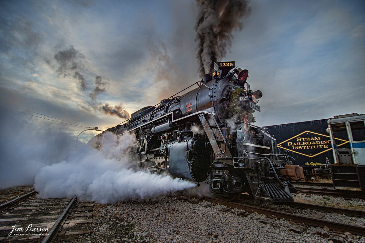 Steam Railroading Institute’s Pere Marquette 1225 pulls off the turntable at Owosso, Michigan, as it prepares for a day of pulling the North Pole Express to Ashley, Michigan on December 16th, 2023.

According to their website, Pere Marquette 1225, the largest and most impressive piece in the Steam Railroading Institute’s collection, is one of the largest operating steam locomotives in Michigan. The 1225 was built in October of 1941 by the Lima Locomotive Works in Lima, Ohio for the Pere Marquette Railway. It’s part of the National Register of Historic Structures and is renowned for its role in the 2004 Warner Brothers Christmas Classic, THE POLAR EXPRESS™. 1225’s blueprints were used as the prototype for the locomotive image as well as its sounds to bring the train in the animated film to life!

Tech Info: Nikon D810, RAW, Nikon 10-24 @ 10mm, f/3.5, 1/320, ISO 90.

#railroad #railroads #train, #trains #railway #railway #steamtrains #railtransport #railroadengines #picturesoftrains #picturesofrailways #besttrainphotograph #bestphoto #photographyoftrains #steamtrainphotography # PereMarquette1225 #bestsoldpicture #JimPearsonPhotography #northpoleexpress #owossomichigan #SteamRailroadingInstitute