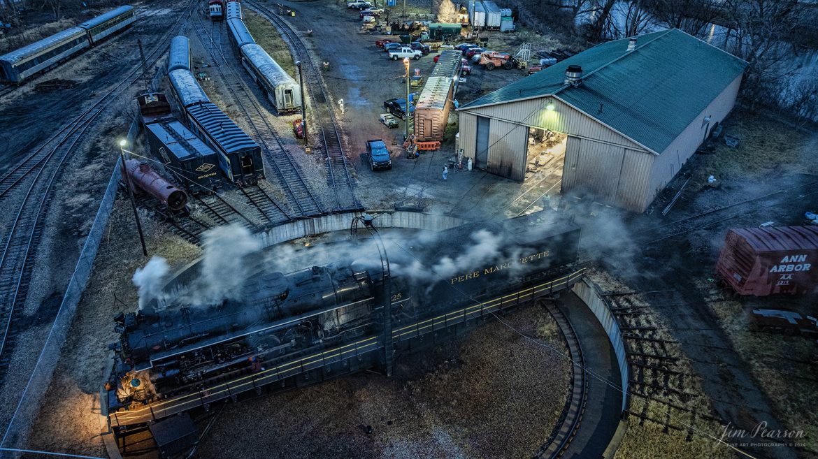 An early morning view of Steam Railroading Institute’s Pere Marquette 1225 as it sits on the turntable at Owosso, Michigan. It was being serviced by crews before it backed up to the ash pit in preparation for another day of pulling the North Pole Express between Owosso and Ashley, Michigan, along the Great Lakes Railroad on December 17th, 2023. 

According to their website, Pere Marquette 1225, the largest and most impressive piece in the Steam Railroading Institute’s collection, is one of the largest operating steam locomotives in Michigan. The 1225 was built in October of 1941 by the Lima Locomotive Works in Lima, Ohio for the Pere Marquette Railway. It’s part of the National Register of Historic Structures and is renowned for its role in the 2004 Warner Brothers Christmas Classic, THE POLAR EXPRESS™. 1225’s blueprints were used as the prototype for the locomotive image as well as its sounds to bring the train in the animated film to life!

Tech Info: DJI Mavic 3 Classic Drone, RAW, 22mm, f/2.8, 1/10, ISO 610.

#railroad #railroads #train, #trains #railway #railway #steamtrains #railtransport #railroadengines #picturesoftrains #picturesofrailways #besttrainphotograph #bestphoto #photographyoftrains #steamtrainphotography # PereMarquette1225 #bestsoldpicture #JimPearsonPhotography #northpoleexpress