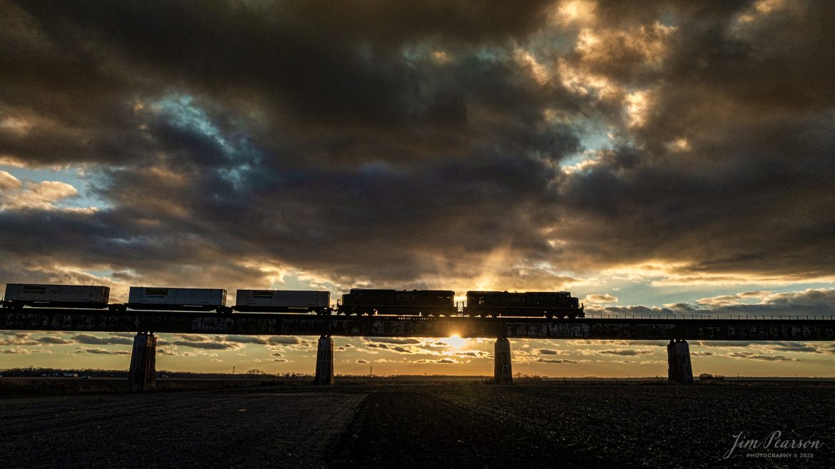 CSX I026 rolls down the viaduct at Rahm, Indiana on the CSX Henderson Subdivision at sunset, December 18th, 2023, on its way north to Evansville, Indiana for a crew change, before heading north to Bedford Park, IL.

Tech Info: DJI Mavic 3 Classic Drone, RAW, 22mm, f/2.8, 1/3200, ISO 170.

#trainphotography #railroadphotography #trains #railways #jimpearsonphotography #trainphotographer #railroadphotographer #csxt #dronephoto #trainsfromadrone #csxhendersonsubdivision