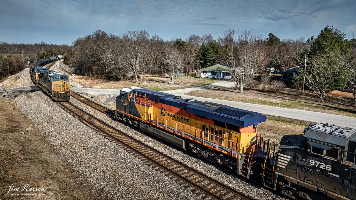 CSXT 790 and 335 lead CSX M513 as it meets the CSX 1973 Chessie Heritage Unit in the siding at the north end of Kelly, Kentucky, as it leads CSX B211, a loaded potash train, on December 22, 2023, on the Henderson Subdivision. 

The Chessie Heritage unit was leading an interesting lash up of one other CSX unit and 3 Norfolk Southern Units. If you check out my Saturday Edited video from this morning (episode 52) you’ll find a couple video clips of this train making its way north.

According to Wikipedia: The three railroads that would make up the Chessie System had been closely related since the 1960s. C&O had acquired controlling interest in B&O in 1962, and the two had jointly controlled WM since 1967.

Chessie System, Inc. was a holding company that owned the Chesapeake and Ohio Railway (C&O), the Baltimore and Ohio Railroad (B&O), the Western Maryland Railway (WM), and Baltimore and Ohio Chicago Terminal Railroad (B&OCT). Trains operated under the Chessie name from 1973 to 1987.

On November 1, 1980, Chessie System merged with Seaboard Coastline Industries to form CSX Corporation. Initially, the three Chessie System railroads continued to operate separately, even after Seaboard’s six Family Lines System railroads were merged into the Seaboard System Railroad on December 29, 1982. That began to change in 1983, when the WM was merged into the B&O. The Chessie image continued to be applied to new and re-painted equipment until July 1, 1986, when CSXT introduced its own paint scheme. In April 1987, the B&O was merged into the C&O. In August 1987, C&O merged into CSX Transportation, a 1986 renaming of the Seaboard System Railroad, and the Chessie System name was retired.

Tech Info: DJI Mavic 3 Classic Drone, RAW, 22mm, f/2.8, 1/2000, ISO 110.

#railroad #railroads #train #trains #bestphoto #railroadengines #picturesoftrains #picturesofrailway #bestphotograph #photographyoftrains #trainphotography #JimPearsonPhotography #csxhendersonsubdivision #csxt #csxheritageunit