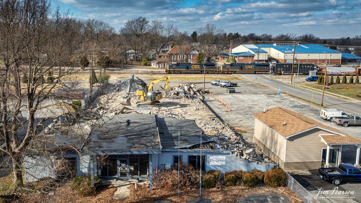 CSX I025 heads south at Madisonville, Kentucky on the CSX Henderson Subdivision on January 4th, 2024, as they pass the demolition of The Messenger Newspaper building in downtown Madisonville.

I spent a lot of good years from 1996-2013 working in this building as a photojournalist and their IT guy! Covered many, many interesting assignments over the years and to the right corner of the building there was a set of stairs with a landing where I would stand to watch and photograph passing trains. It got to where if I was working and someone in the newsroom heard a train coming, they’d call out to me “Train Jim!” LOL I thought if was fitting I get my last shot of the building with a train passing it. 

The building is making way for a new Dunkin Donuts! The offices for the paper are now located in a strip mall about a mile away, and while it still serves our community, it’s a shell of what it was during the time I was there. A sad state of many papers not only across the USA, but the world.

Tech Info: DJI Mavic 3 Classic Drone, RAW, 22mm, f/2.8, 1/1600, ISO 100.

#railroad #railroads #train #trains #bestphoto #railroadengines #picturesoftrains #picturesofrailway #bestphotograph #photographyoftrains #trainphotography #JimPearsonPhotography #csxhendersonsubdivision #csxt