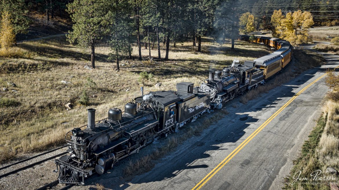 On October 18th, 2023, double-header steam locomotives, Denver and Rio Grande Western 473 and 493 pull into Rockwood, CO, with one of the daily passenger trains that run between Durango and Silverton, Colorado.

According to Wikipedia: The Durango and Silverton Narrow Gauge Railroad, often abbreviated as the D&SNG, is a 3 ft (914 mm) narrow-gauge heritage railroad that operates on 45.2 mi (72.7 km) of track between Durango and Silverton, in the U.S. state of Colorado. The railway is a federally designated National Historic Landmark and was also designated by the American Society of Civil Engineers as a National Historic Civil Engineering Landmark in 1968.

Tech Info: DJI Mavic 3 Classic Drone, RAW, 22mm, f/2.8, 1/800, ISO 100.

#railroad #railroads #train #trains #bestphoto #railroadengines #picturesoftrains #picturesofrailway #bestphotograph #photographyoftrains #trainphotography #JimPearsonPhotography #DurangoandSilvertonRailroad #trending