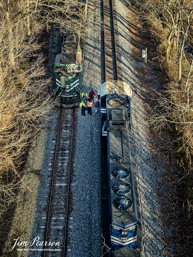 Paducah and Louisville (PAL) crews on the Louisville Gas and Electric Paducah and Louisville (PAL) empty and loaded coal trains meet at Caneyville, Kentucky, and exchange trains on February 1st, 2024. The Louisville crew will take the loaded train back to their home territory north on the PAL to deliver their load to Louisville Gas and Electric power plant, outside of Louisville, Ky. The Madisonville crew will take the empty train back south for another load of coal from Warrior Coal Mine.

Tech Info: DJI Mavic 3 Classic Drone, RAW, 22mm, f/2.8, 1/320, ISO 100.

#trainphotography #railroadphotography #trains #railways #jimpearsonphotography #trainphotographer #railroadphotographer #csxt #dronephoto #trainsfromadrone #paducahandlouisvillerailroad #trending