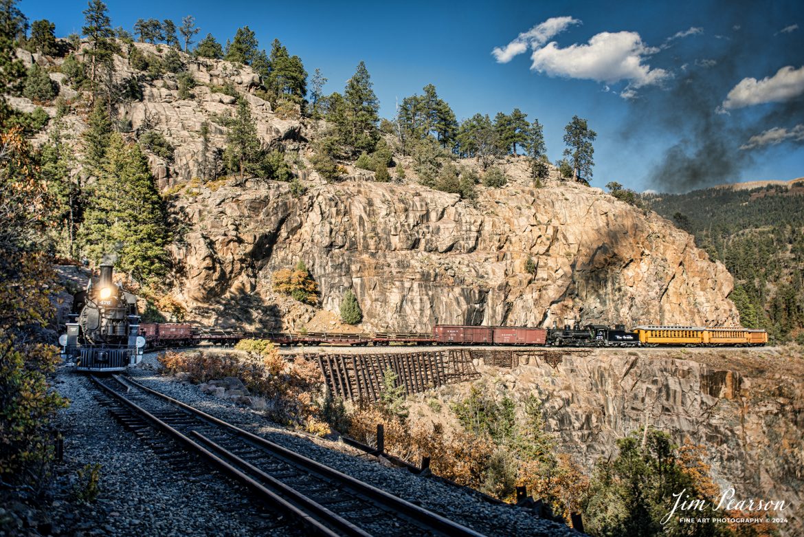 Denver and Rio Grande Western steam charter with locomotives 476 and 473 as a mid-train helper pull a freight and passenger train through Horseshoe Curve during our two-day charter between Durango and Silverton, Colorado on October 17th, 2023.

According to Wikipedia: The Durango and Silverton Narrow Gauge Railroad, often abbreviated as the D&SNG, is a 3 ft (914 mm) narrow-gauge heritage railroad that operates on 45.2 mi (72.7 km) of track between Durango and Silverton, in the U.S. state of Colorado. The railway is a federally designated National Historic Landmark and was also designated by the American Society of Civil Engineers as a National Historic Civil Engineering Landmark in 1968.

Tech Info: DJI Mavic 3 Classic Drone, RAW, 22mm, f/2.8, 1/1000, ISO 72.

#railroad #railroads #train #trains #bestphoto #railroadengines #picturesoftrains #picturesofrailway #bestphotograph #photographyoftrains #trainphotography #JimPearsonPhotography #DurangoandSilvertonRailroad #trending