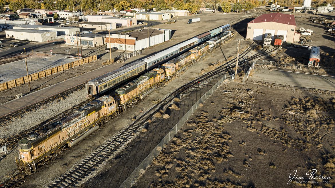 During my trip to Colorado in 2023 to chase steam we stayed in Alamosa for the Cumbres and Toltec portion of the trip. On October 18th, 2023, I captured this view of BUGX (ex-BNSF) power and coaches sitting in the Colorado Pacific Rio Grande Railroad (SL&RG) yard there. 

Tech Info: DJI Mavic 3 Classic Drone, RAW, 22mm, f/8, 1/1250, ISO 160.

#trainphotography #railroadphotography #trains #railways #jimpearsonphotography #trainphotographer #railroadphotographer #dronephoto #trainsfromadrone #ColoradoTrains