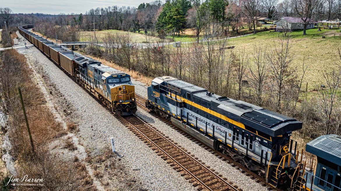 Southbound CSX Chesapeake & Ohio Heritage unit 1869 leads hot intermodal, CSX I025, as it meets northbound empty coal train E904 at Nortonville, Kentucky, on the Henderson Subdivision on February 29th, 2024.

According to the CSX Website: A locomotive commemorating the proud history of the Chesapeake and Ohio Railway has entered service as the fifth in the CSX heritage series celebrating the lines that came together to form the modern railroad.

Numbered CSX 1869 in honor of the year the C&O was formed in Virginia from several smaller railroads, the newest heritage locomotive sports a custom paint design that includes today’s CSX colors on the front of the engine and transitions to a paint scheme inspired by 1960s era C&O locomotives on the rear two-thirds.

The C&O Railway was a major line among North American freight and passenger railroads for nearly a century before becoming part of the Chessie System in 1972 and eventually merging into the modern CSX. In 1970, the C&O included more than 5,000 route miles of track stretching from Newport News, Virginia, to Chicago and the Great Lakes.

Designed and painted at CSX’s locomotive shop in Waycross, Georgia, the C&O unit will join four other commemorative units in revenue service on CSX’s 20,000-mile rail network.

The heritage series is reinforcing employee pride in the history of the railroad that continues to move the nation’s economy with safe, reliable, and sustainable rail-based transportation services.

Tech Info: DJI Mavic 3 Classic Drone, RAW, 22mm, f/2.8, 1/2500, ISO 170.

#trainphotography #railroadphotography #trains #railways #jimpearsonphotography #trainphotographer #railroadphotographer #csxt #dronephoto #trainsfromadrone #trending #CSXHeritageUnit