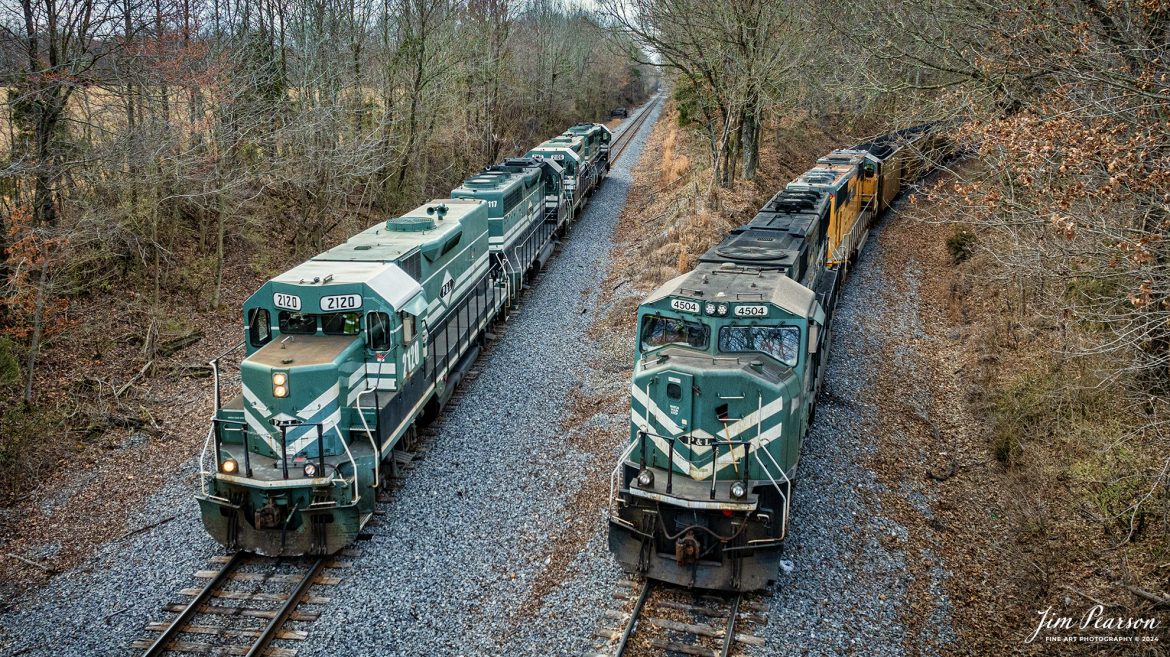 Paducah and Louisville Railway local WW1, running engines light northbound, passes a loaded Louisville Gas and Electric (LGE) coal train siting on the Warrior Mine lead, as WW1 heads to Atkison Yard at Madisonville, Ky and Central City, Ky to do their interchange work on February 29th, 2024. The LGE train will get a crew in about another hour and then head north to the power plant outside of Louisville, Ky.

Tech Info: DJI Mavic 3 Classic Drone, RAW, 22mm, f/2.8, 1/1600, ISO 260.

#trainphotography #railroadphotography #trains #railways #jimpearsonphotography #trainphotographer #railroadphotographer #csxt #dronephoto #trainsfromadrone #trending #PaducahandLouisvilleRailway